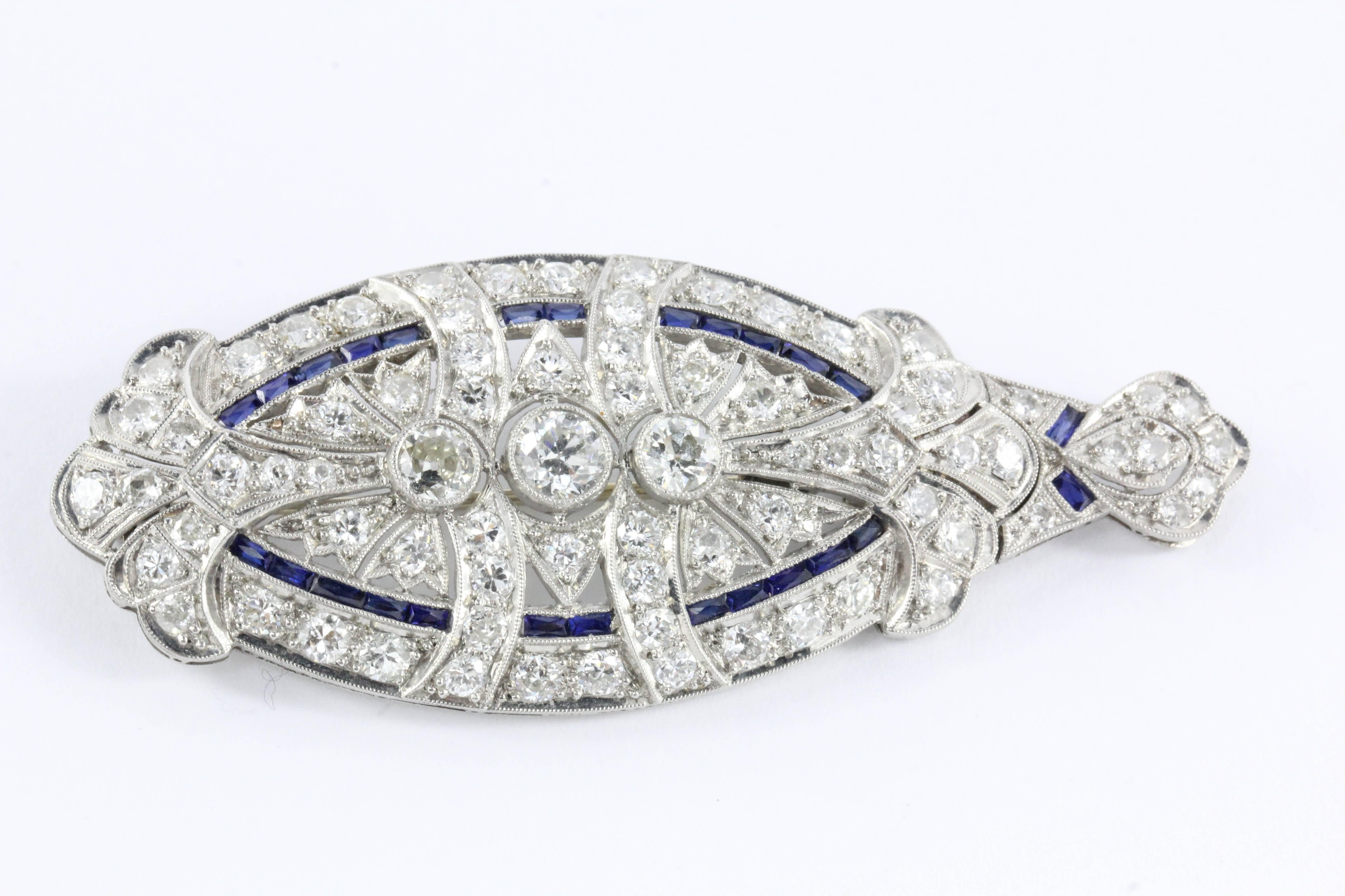 A gorgeous Edwardian 5 carat total weight diamond sapphire platinum brooch. The piece can be converted from a pendant to a brooch with a fine crafted detachable screw located on the bale. The center stone is a .5 carat old European cut I color VVS2