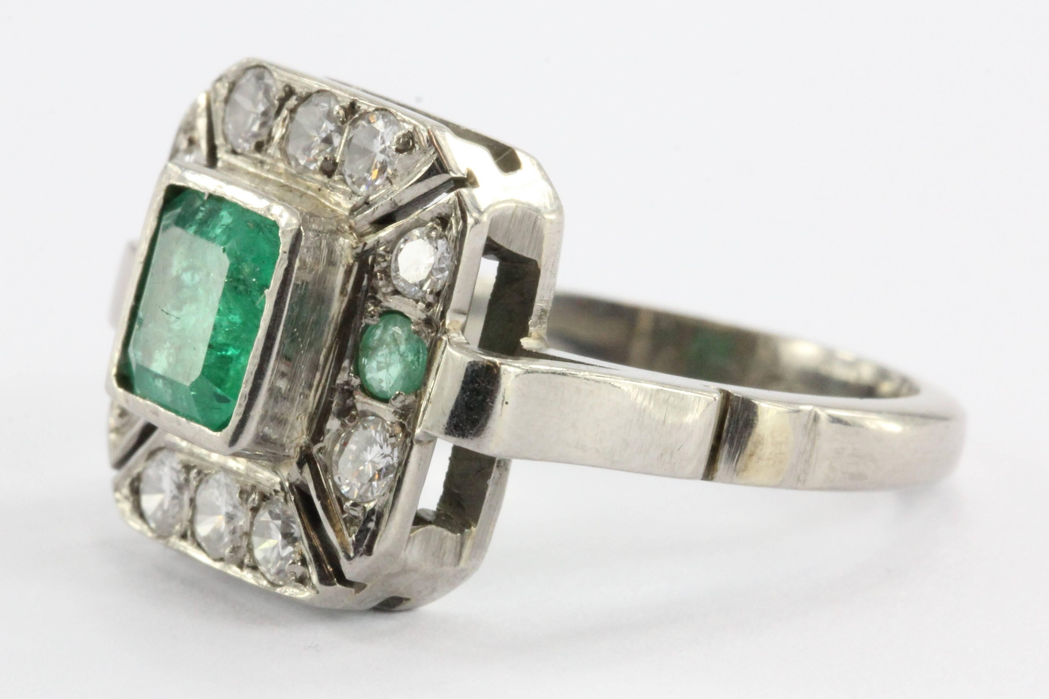 Art Deco Emerald & Diamond Engagement Ring set in platinum. The ring is of a thick sturdy construction and it has and will hold up to regular wear. The center stone is a square cut 1 carat emerald. The emerald is a brilliant vibrant green with
