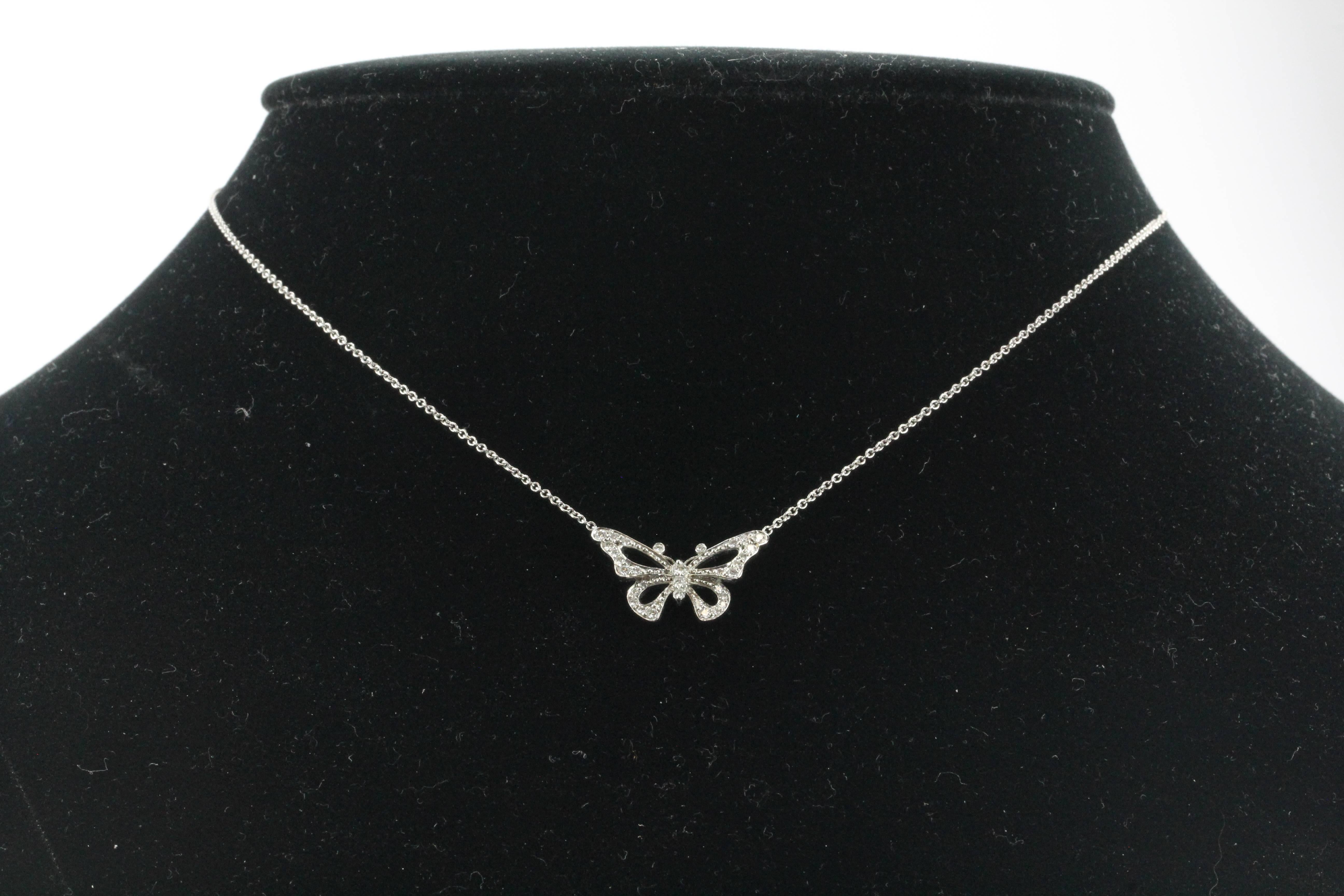 Tiffany & Co Platinum & Diamond Butterfly Pendant Necklace. The piece is in excellent estate condition and ready to wear and comes with its original Tiffany pouch. The piece is signed Tiffany & Co PT 950. It is set with .20 carats of Vs1 clarity, G