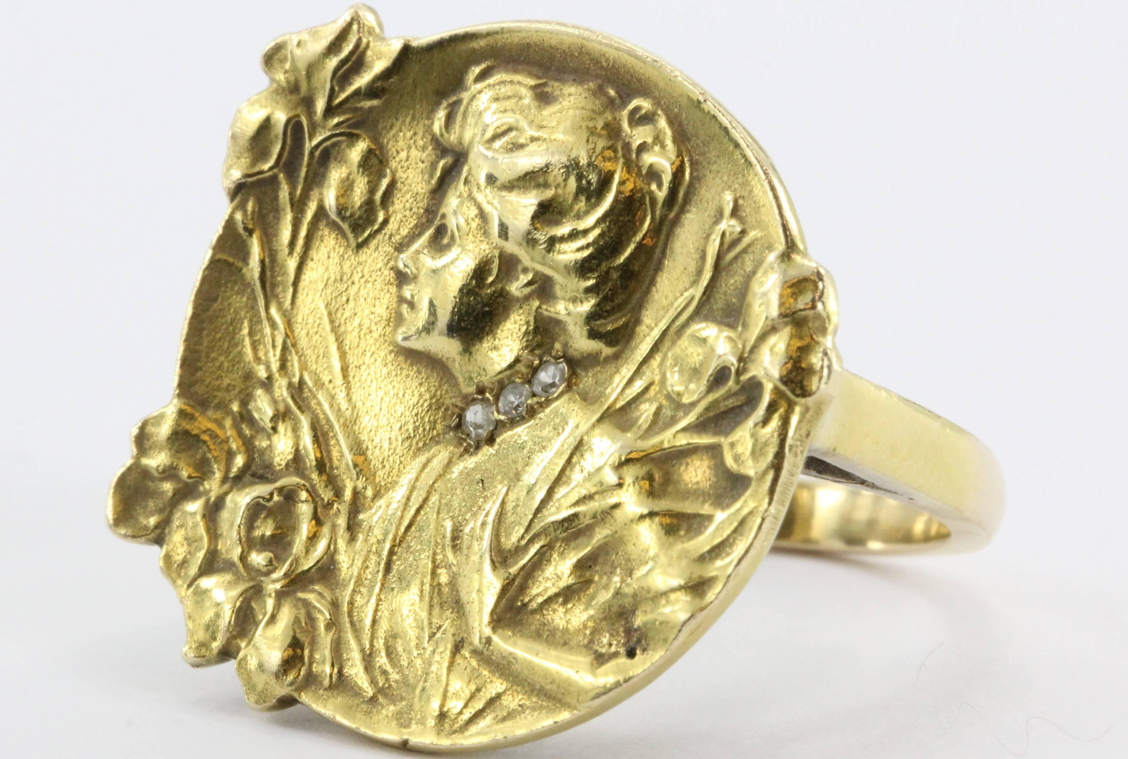 Art Nouveau 14K Gold & Diamond Gibson Girl w/ Iris Ring. The ring is in excellent estate condition and ready to wear. It is marked 14K. The rings face depicts the profile of a turn of the century Gibson girl in a field of Irises. She has a choker of