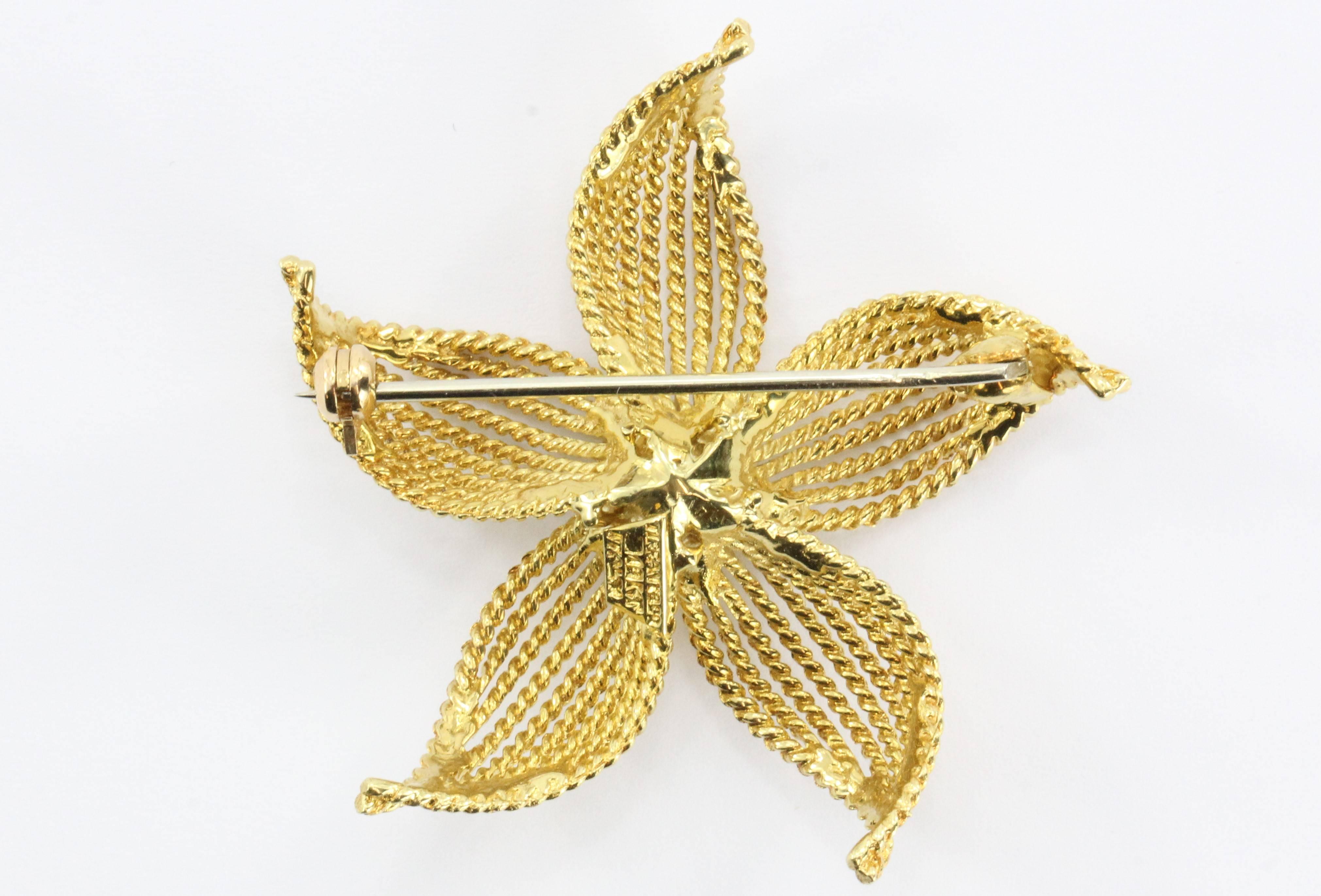 18K Yellow Gold Tiffany & Co Flower Brooch. The piece is in excellent estate condition, ready to wear. It is signed Tiffany & Co. 18K Italy. 

The piece measures 1.75" x 1.75" and weighs a total of 12.9 grams