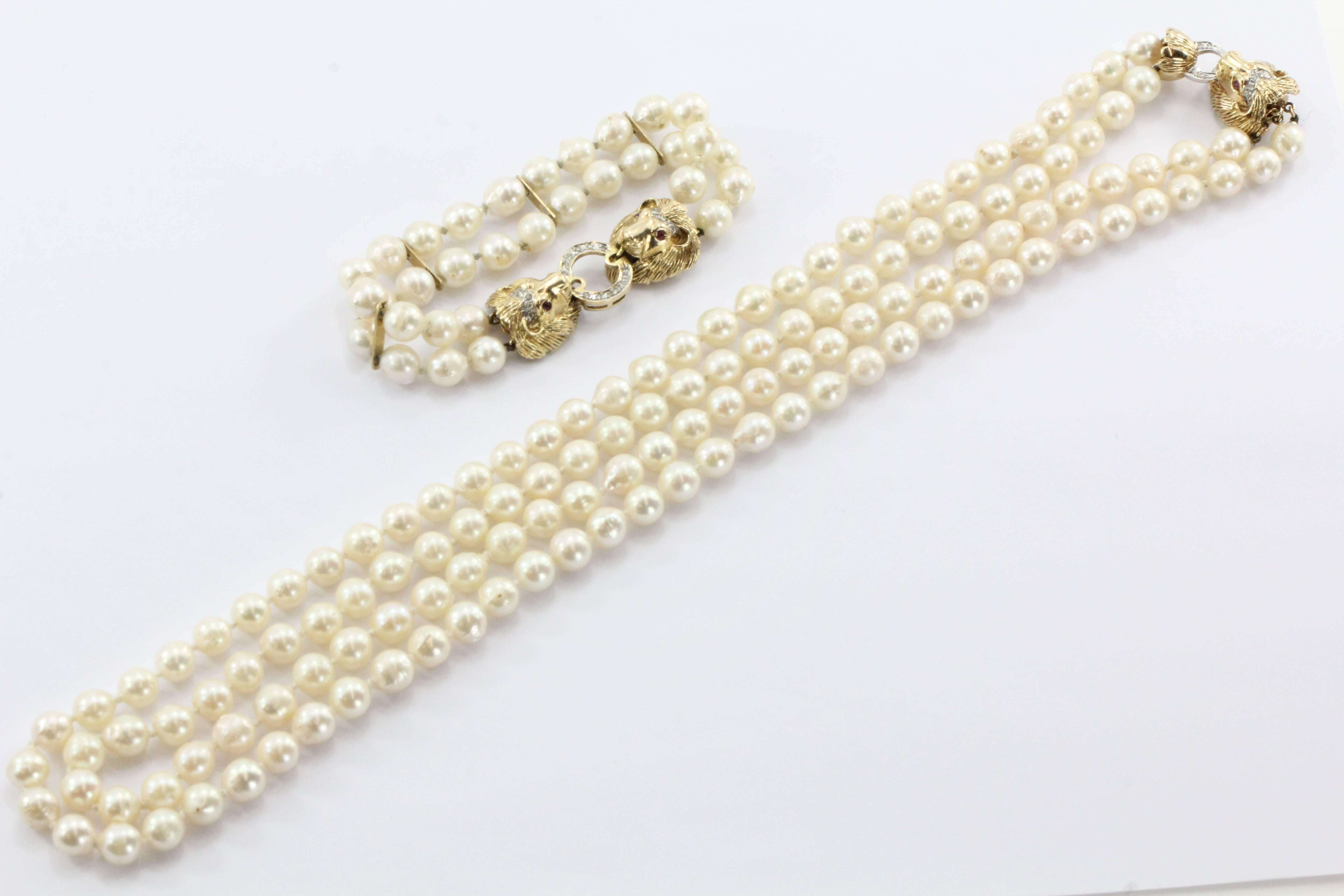 Antique 14K Gold Diamond Ruby Lion Head Double Strand Pearl Necklace & Bracelet Set. The set is in great antique estate condition and ready to wear. A few of the pearls are damaged with cracked nacre. The pieces are both hallmarked 585 14K. Both