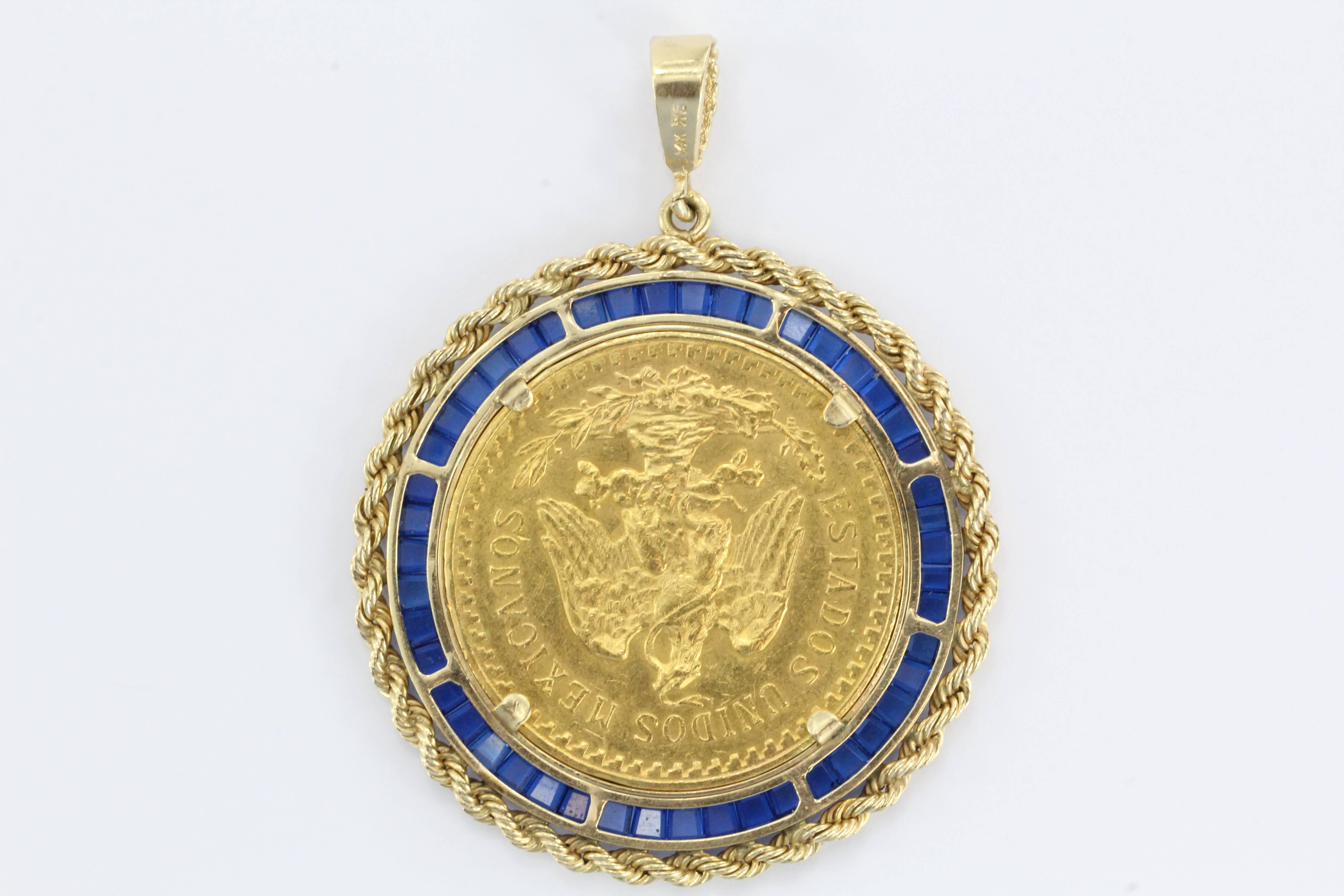 Large 1923 Gold Angel Coin Pendant set in 14K Yellow Gold & Sapphire Bezel. The pendant is in excellent estate condition and ready to wear. The coin is a 1923 Mexican 50 Peso gold coin. The coin is 90% / 21.6 Carat Gold and weighs 1.2057 Troy oz NOT