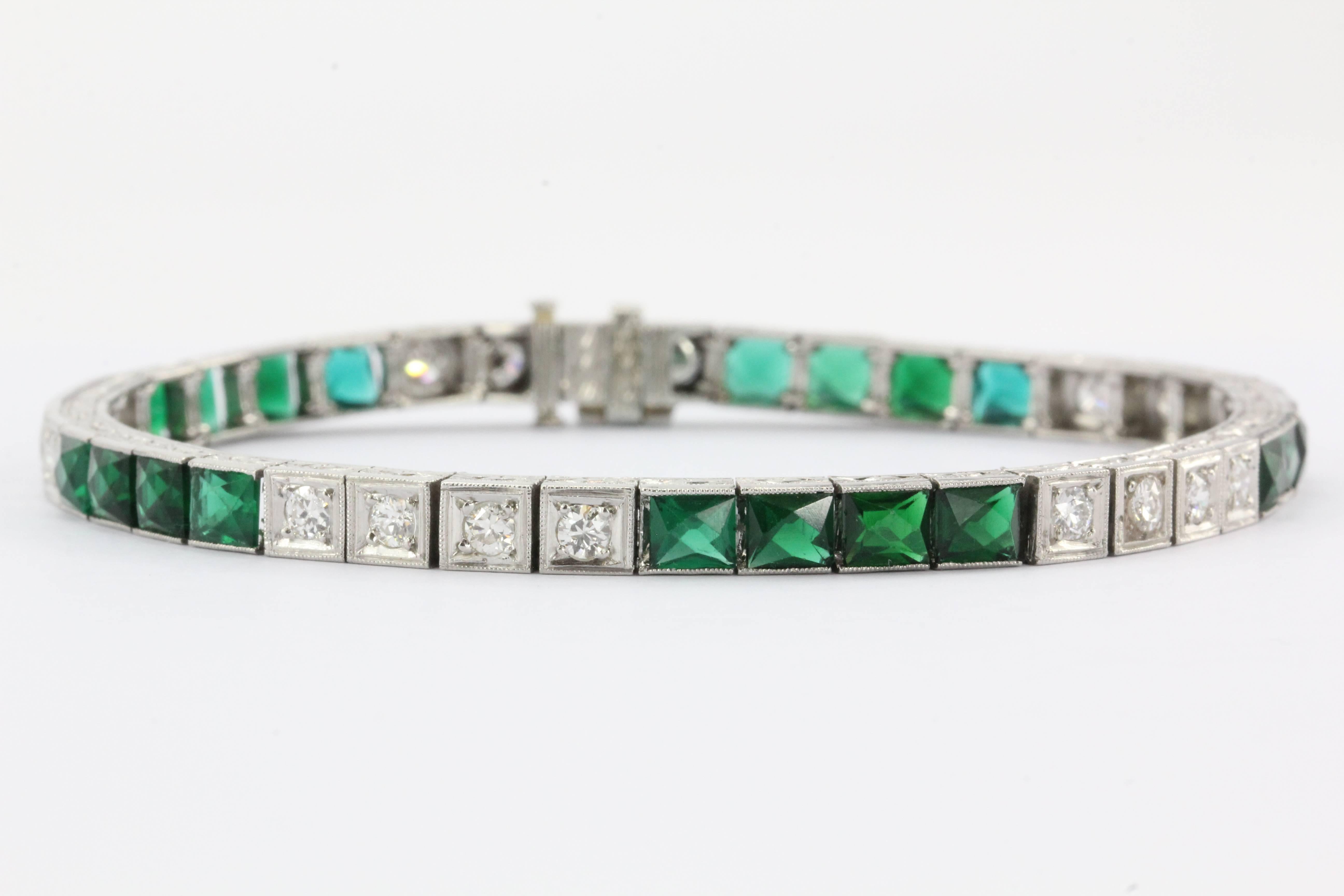Vintage Art Deco Platinum French Cut Emerald & Diamond Tennis Bracelet. The bracelet is in excellent estate condition and ready to wear. It is set with 20 french cut emeralds that come to approximately 6 carats and 20 diamonds that add an additional