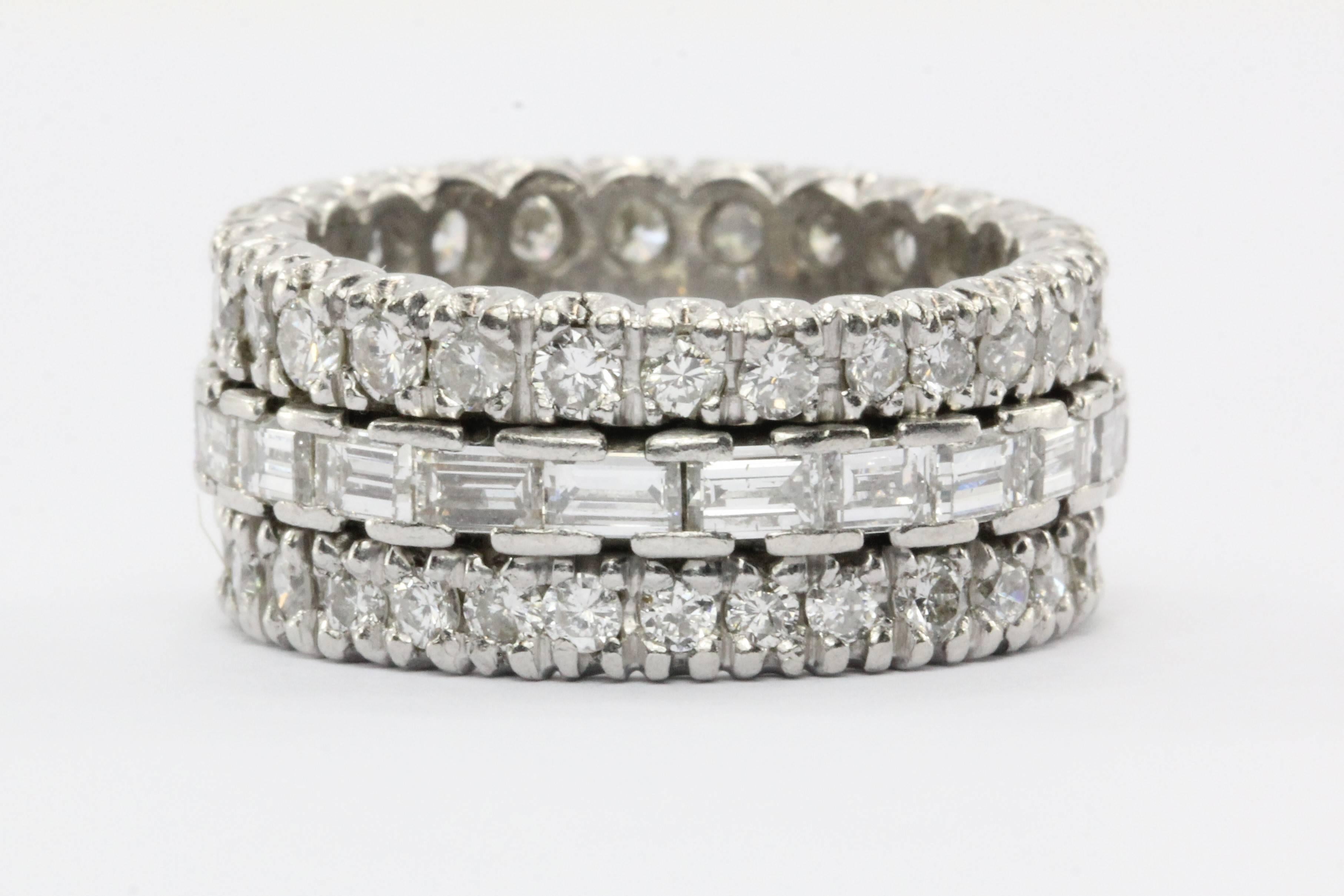 Platinum 4 CTW Diamond Eternity Band Ring. The ring is in excellent estate condition and ready to wear. It is set with approximately 4 carats of diamonds. The center of the band has approximately 2 carats of E/F color Vvs1- Vs2 clarity Baguette