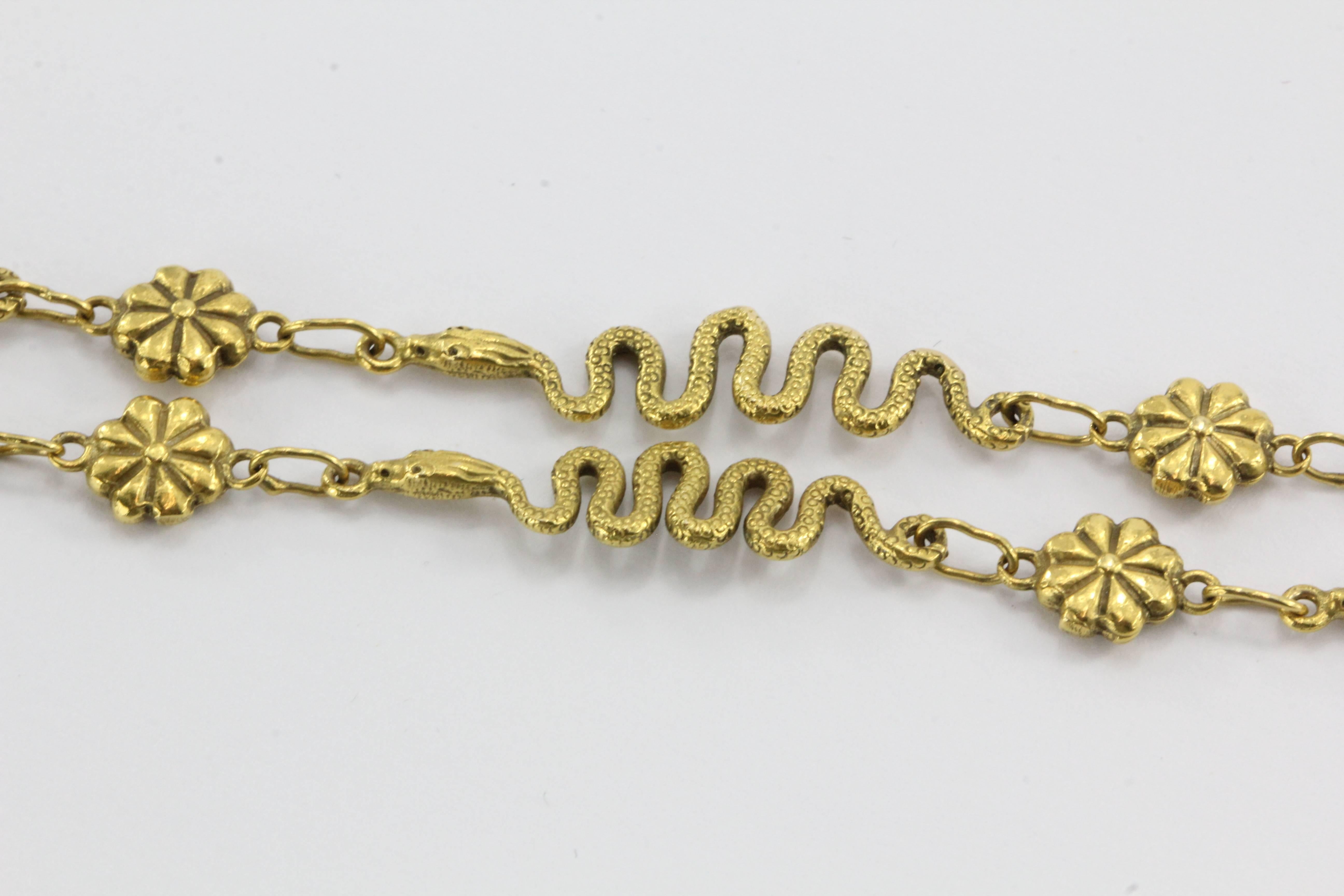 14K Gold Figural Snake Link & Serpent Necklace. The necklace is in excellent estate condition and ready to wear. It is hallmarked 14K on the clasp. There are ten 1