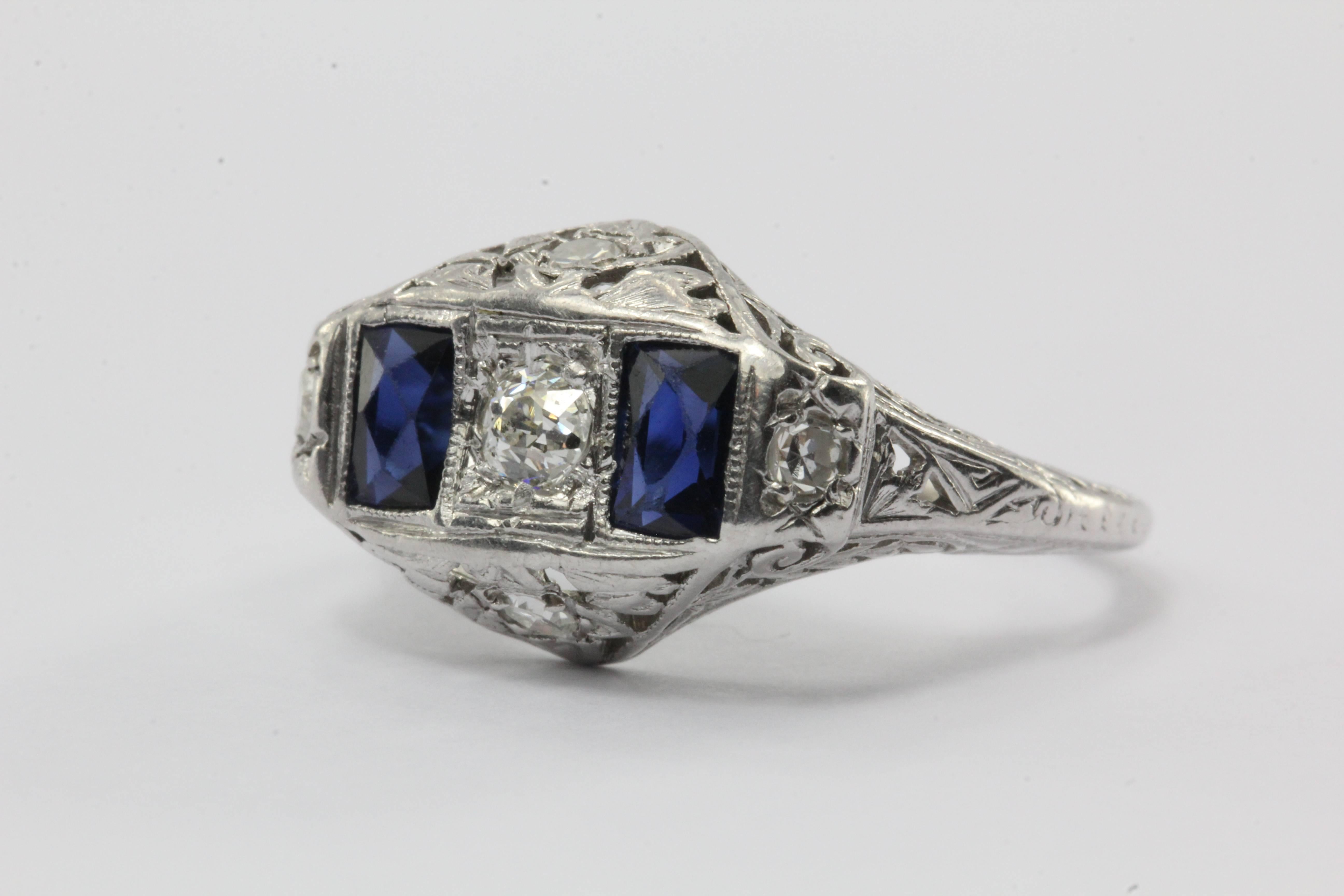 Antique Art Deco Platinum Old European Diamond & Sapphire Ring. The ring is in great antique condition and ready to wear. The ring is set with approximately .30 carats of G/H color, Si clarity old European cut diamonds and two .50 carat french cut