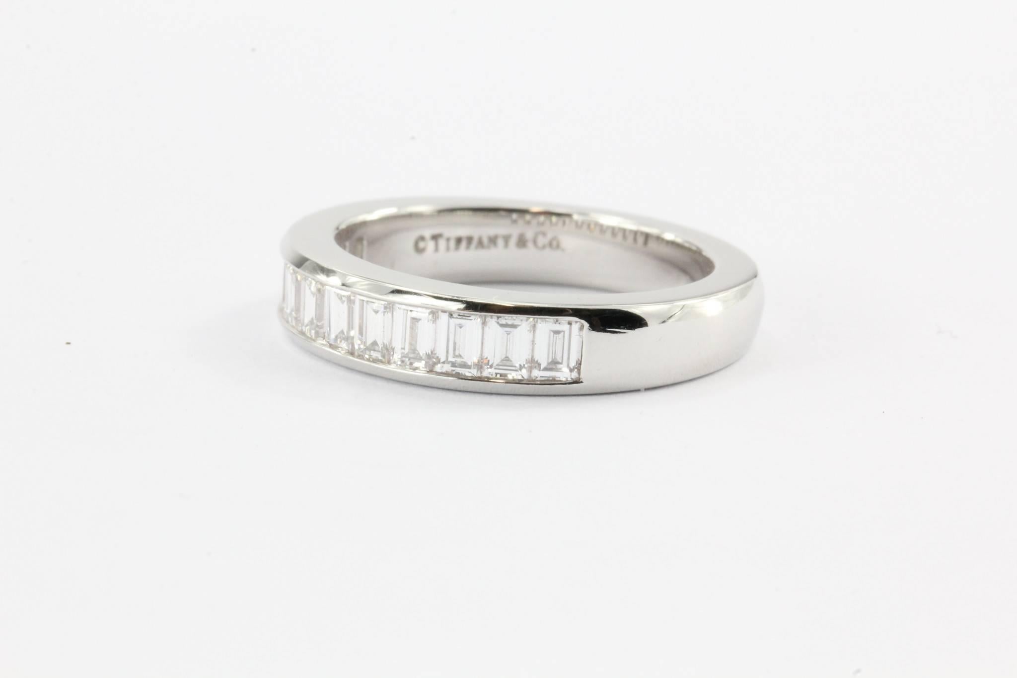 Channel-set band ring with a half circle of baguette diamonds in platinum. 3 mm wide.
Ring size 6
Diamonds carat total weight: .96 
VS1 clarity, G color
Band still sold in stores!
Retail price: $6025