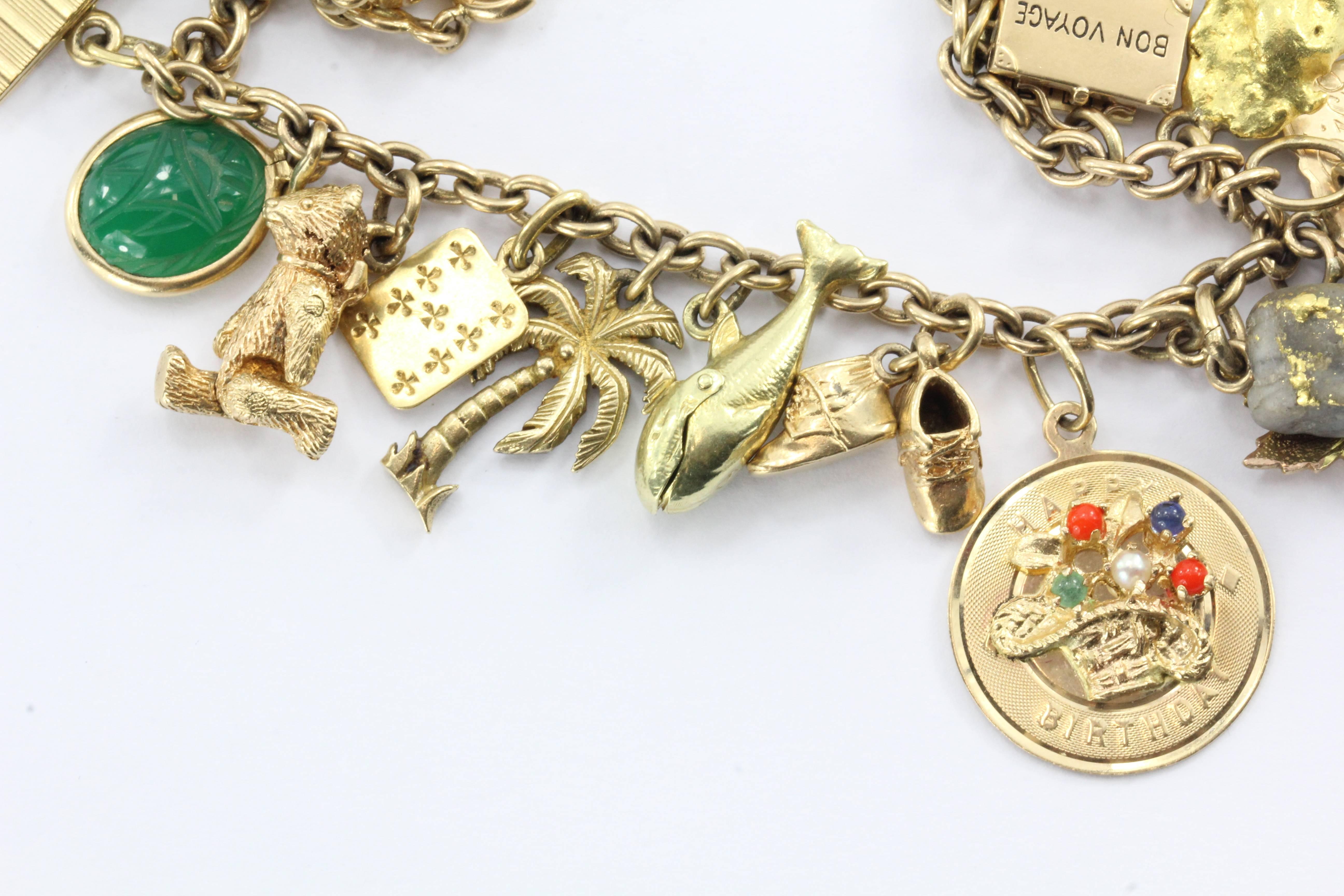 Antique 1940's 14k Gold Loaded 26 Charm Bracelet w Cartier & Tiffany Co Charm. The bracelet is in excellent estate condition and ready to wear. The piece dates from either World War II or the Korean War 1940 - 1955. 

The bracelet measures 7.5