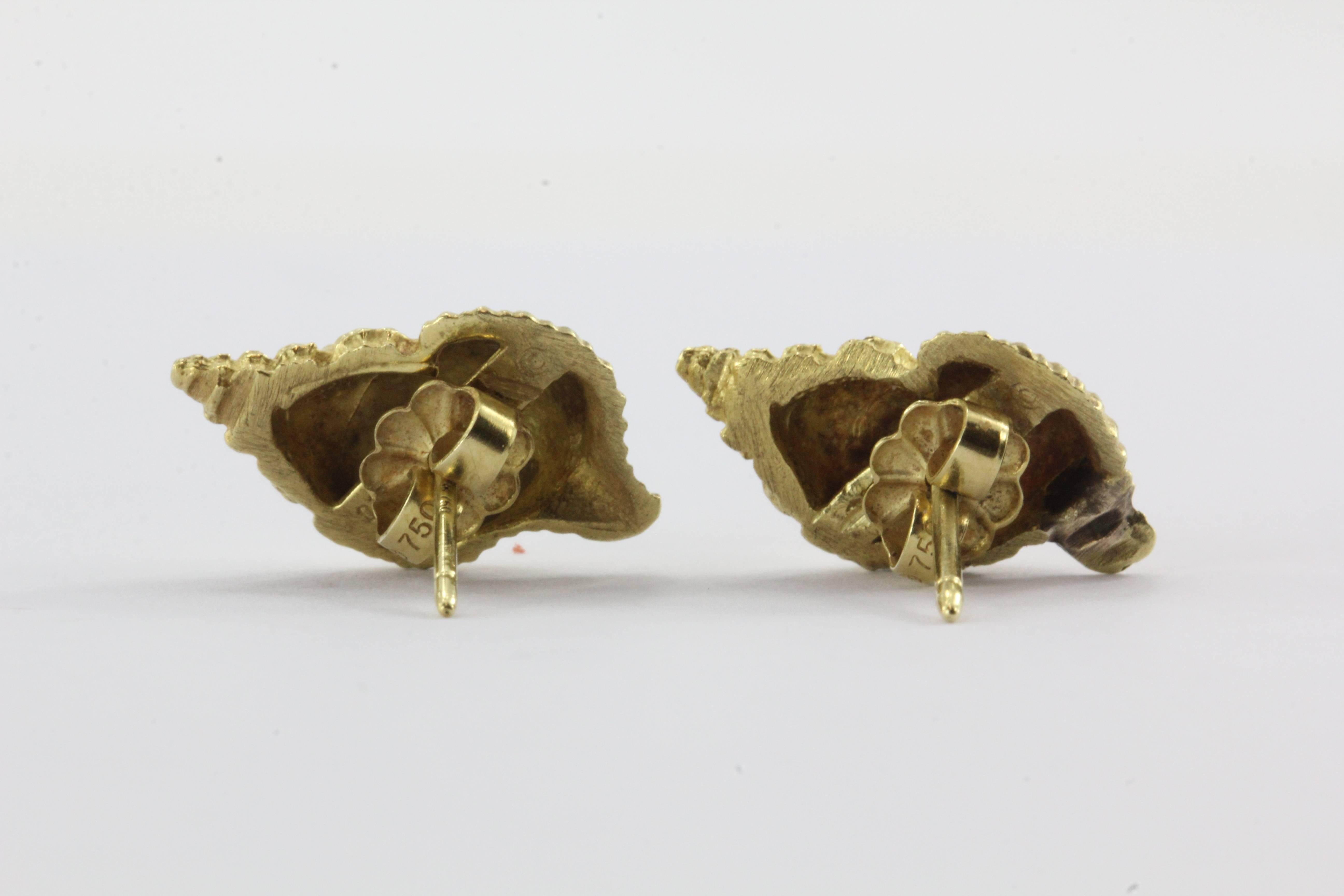 Rare, Tiffany & Co 750 18K Gold Brushed Conch Shell Earrings. The earrings are in excellent used condition and ready to wear. It comes in a Tiffany pouch but is missing the box . The earrings are signed 
