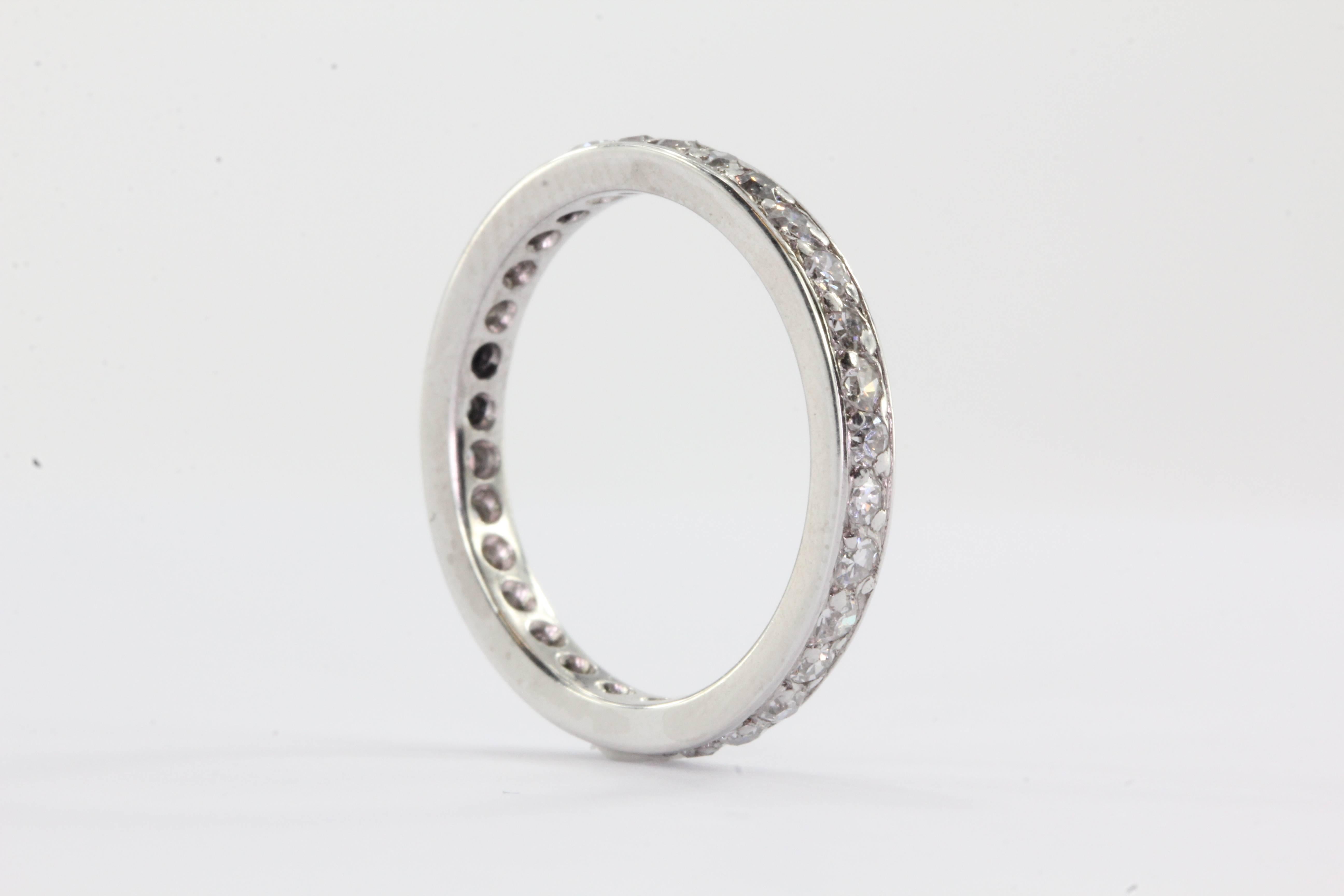 Antique Platinum 1 Carat Total Weight Diamond Eternity Band Ring Size 6. The ring is in excellent estate condition and ready to wear. The ring is set with approximately 1 carat of G/H color Vs1 clarity single cut diamonds. The ring is a size 6 and