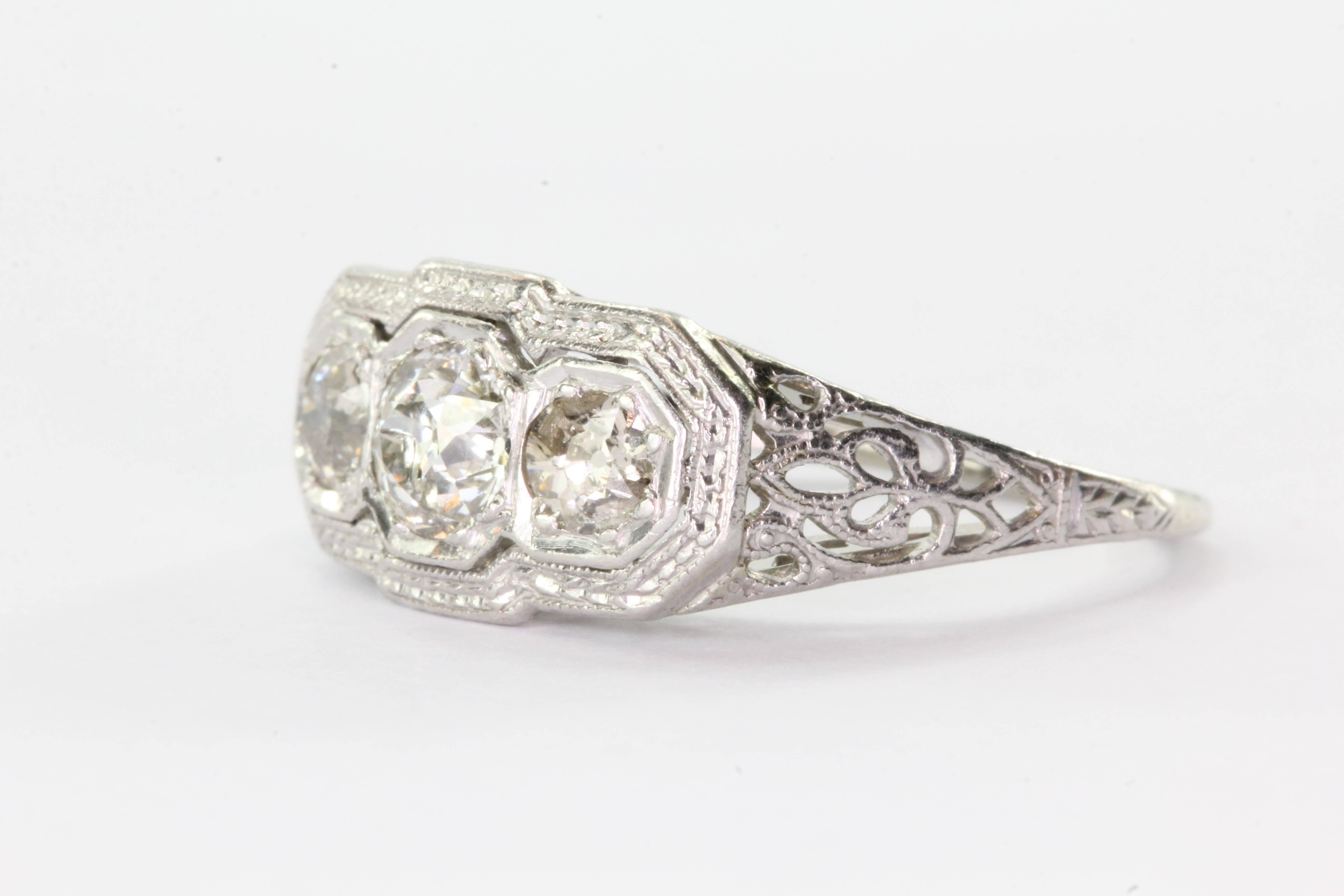 Antique Art Nouveau 18K White Gold & Platinum 3 Stone Diamond Engagement Ring. The ring is in excellent estate condition and ready to wear. Most of the ring is 18K white gold but the diamonds are set in platinum. The ring is set with three old