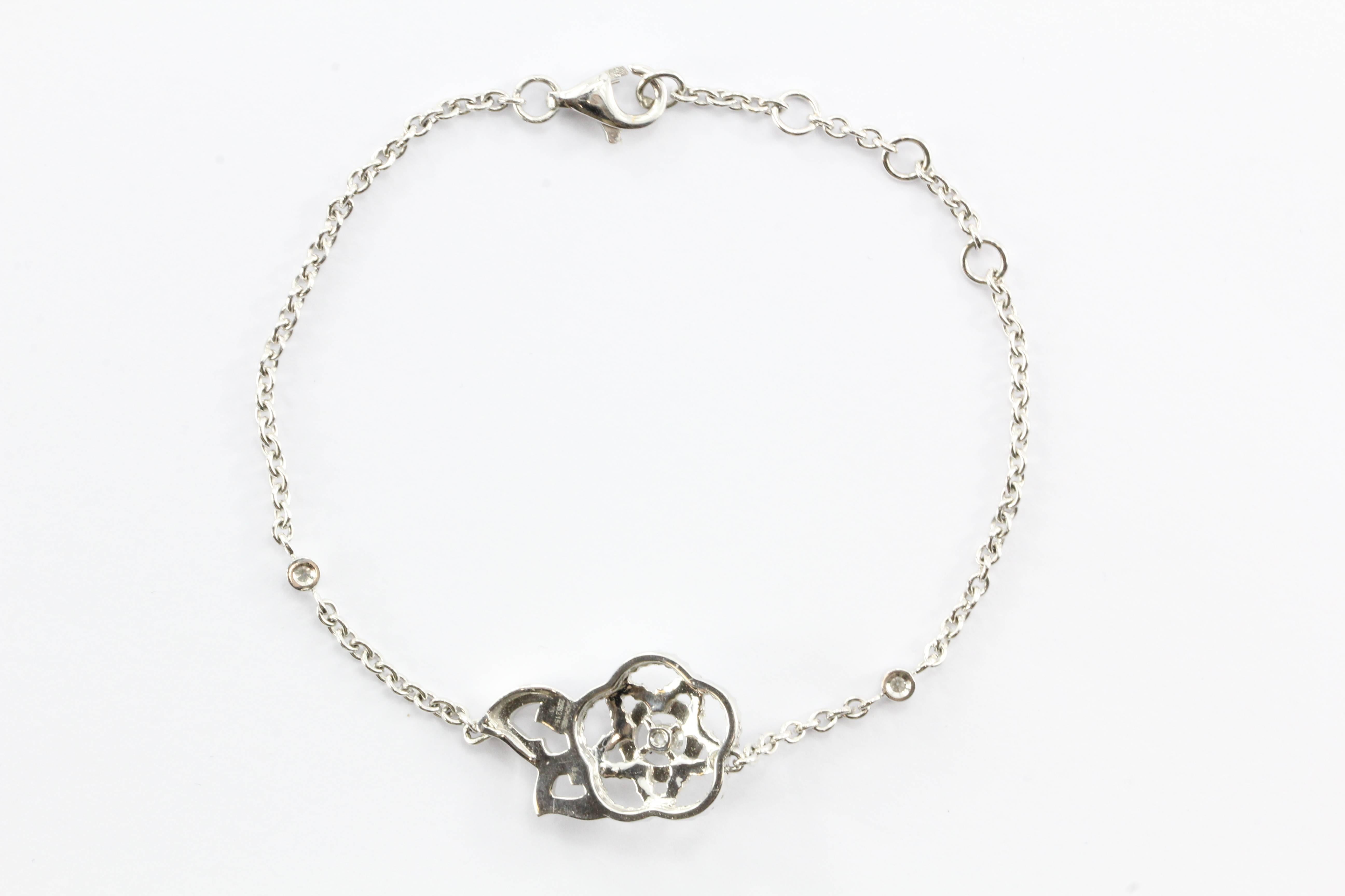 New CHANEL Camelia Brode 18K White Gold & Diamond Bracelet.  The piece is made of 18K white gold and set with approximately .70 carats of diamonds. It is signed CHANEL 750 on the back of the flower and has the French 18K eagle head mark on the