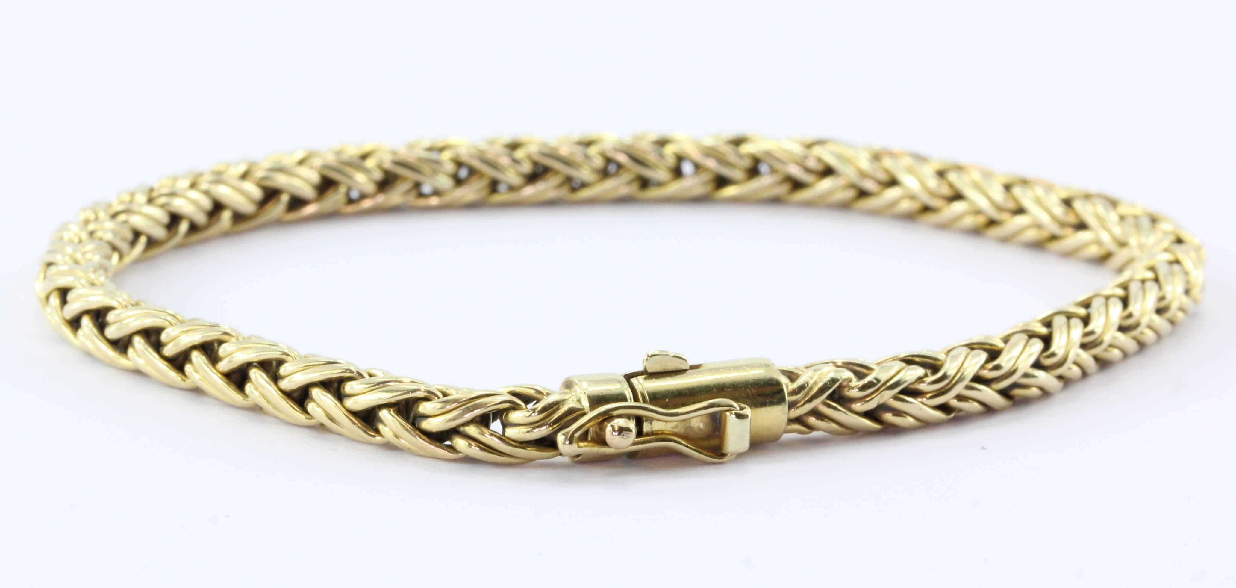 Tiffany & Co 18K Gold Woven Braided Bracelet 7.4". The bracelet is in excellent estate condition and ready to wear. It comes with a pouch and box. The piece is signed "Tiffany & Co 750". It measures about 7.4" long x