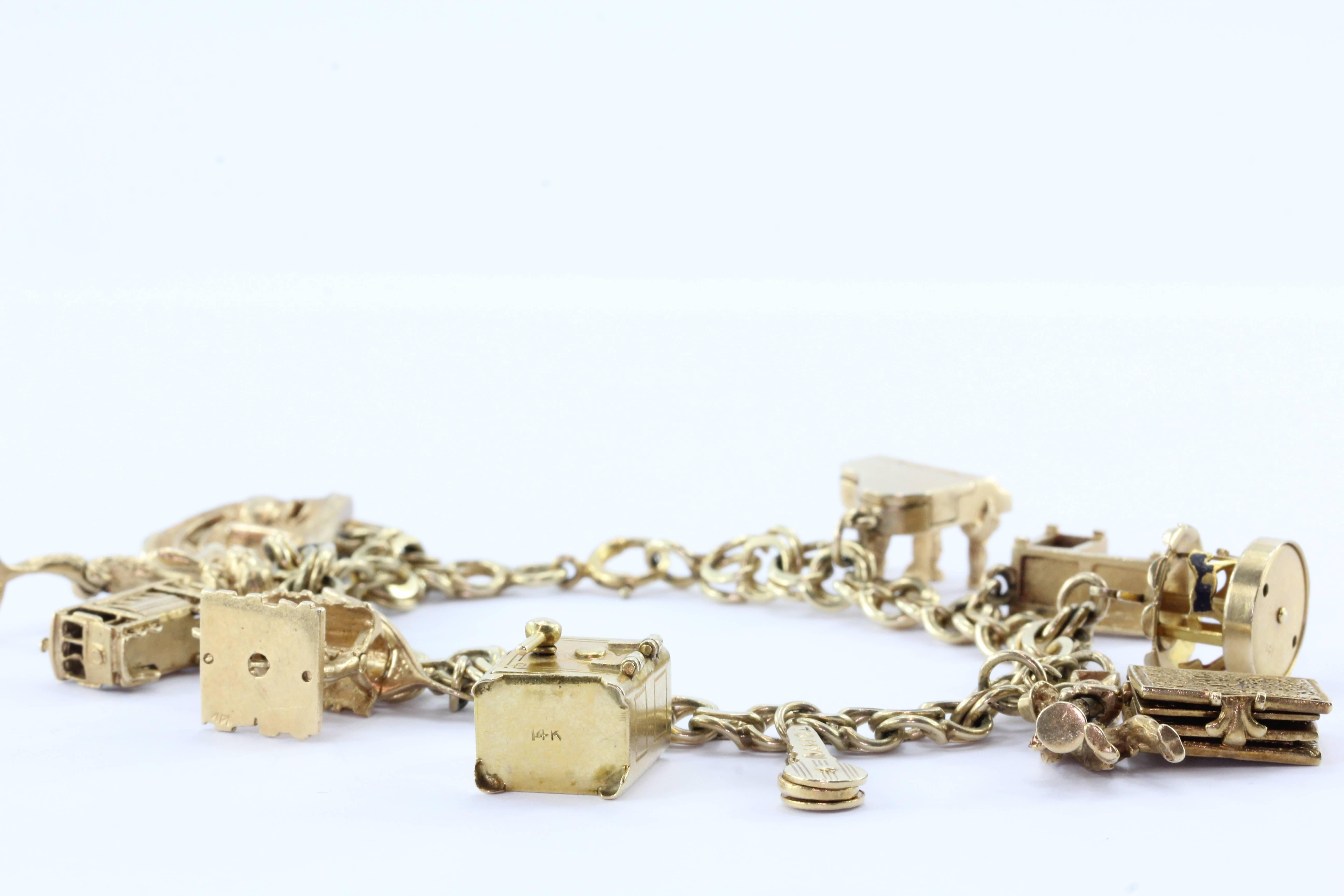 14K Gold 12 Movable Charms Charm Bracelet Circa 1950's. The piece is in excellent estate condition and ready to wear. All but two of the charms have pieces that move. The bracelet and all of the charms are hallmarked 14K. The bracelet measures