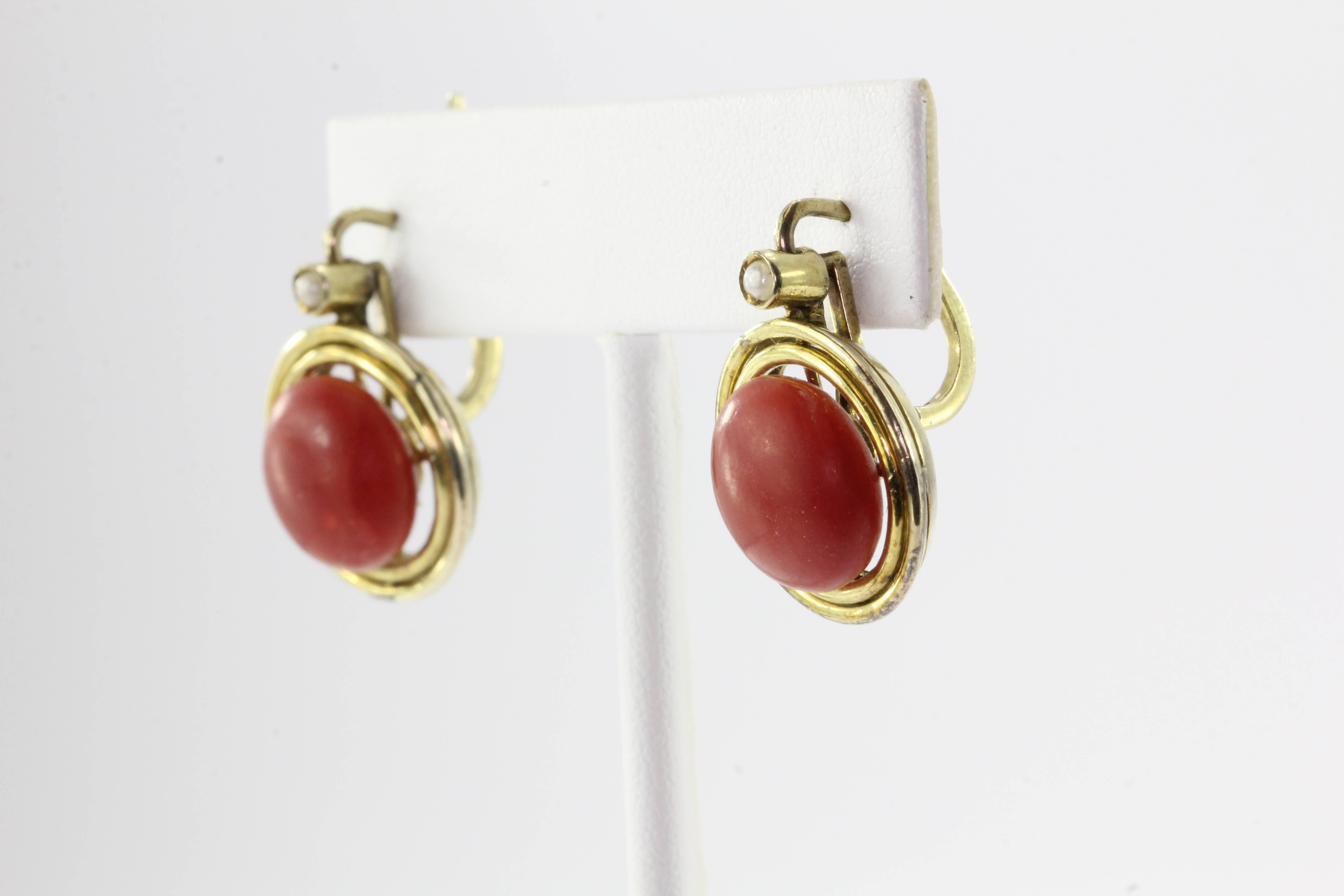 Victorian Red Oxblood Coral Seed Pearl 14K Gold Earrings. The earrings are in excellent estate condition and ready to wear. The piece are made of 14K yellow gold and set with seed pearls and oxblood red coral. The coral measures about 12.5mm in