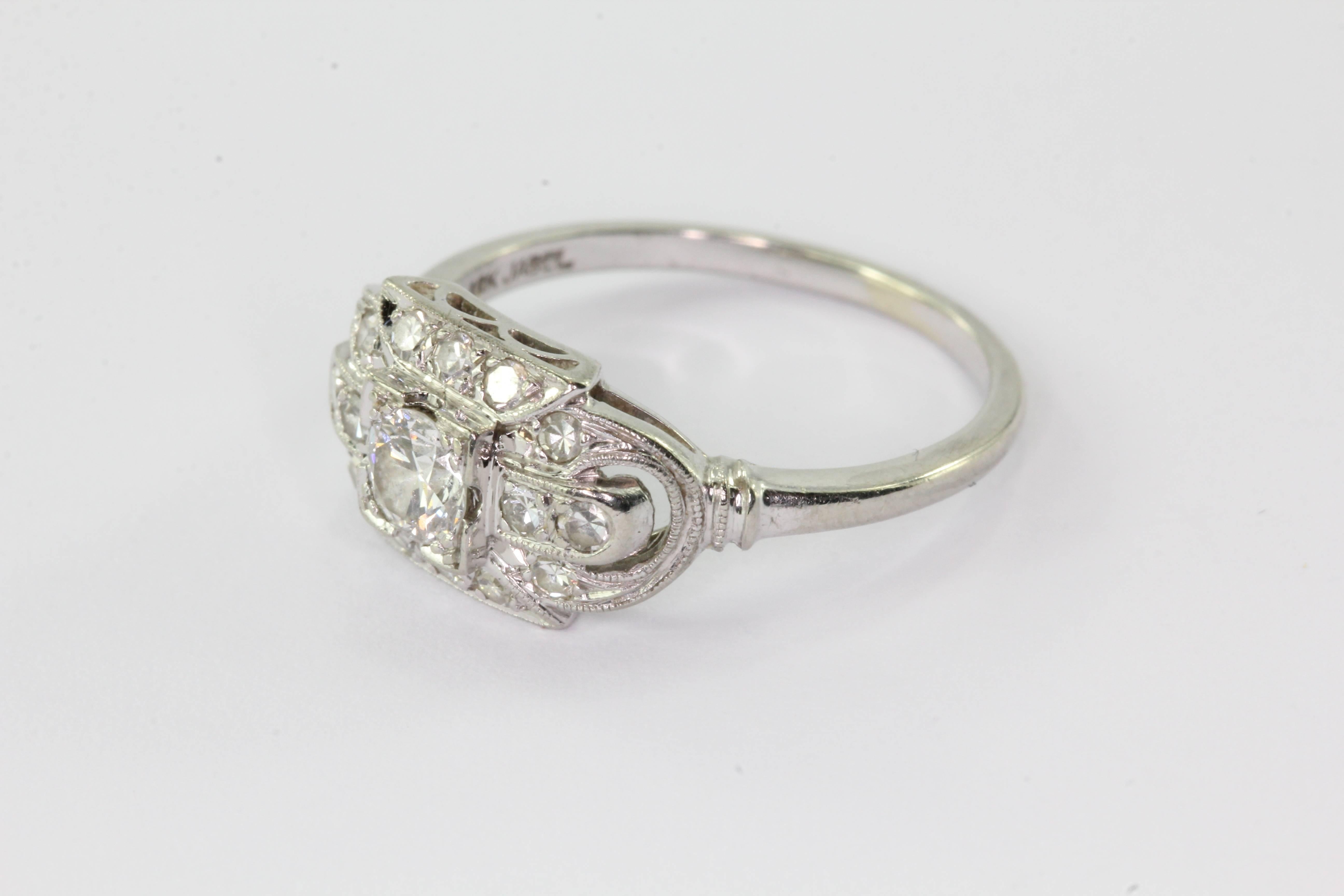18K White Gold Transition Cut Diamond Art Deco Engagement Ring by JABEL. The ring is in excellent estate condition and ready to wear. The ring is signed JABEL 18K. Jabel was founded in 1916 by Jack J. Abelson out of Newark NJ. The ring is set with