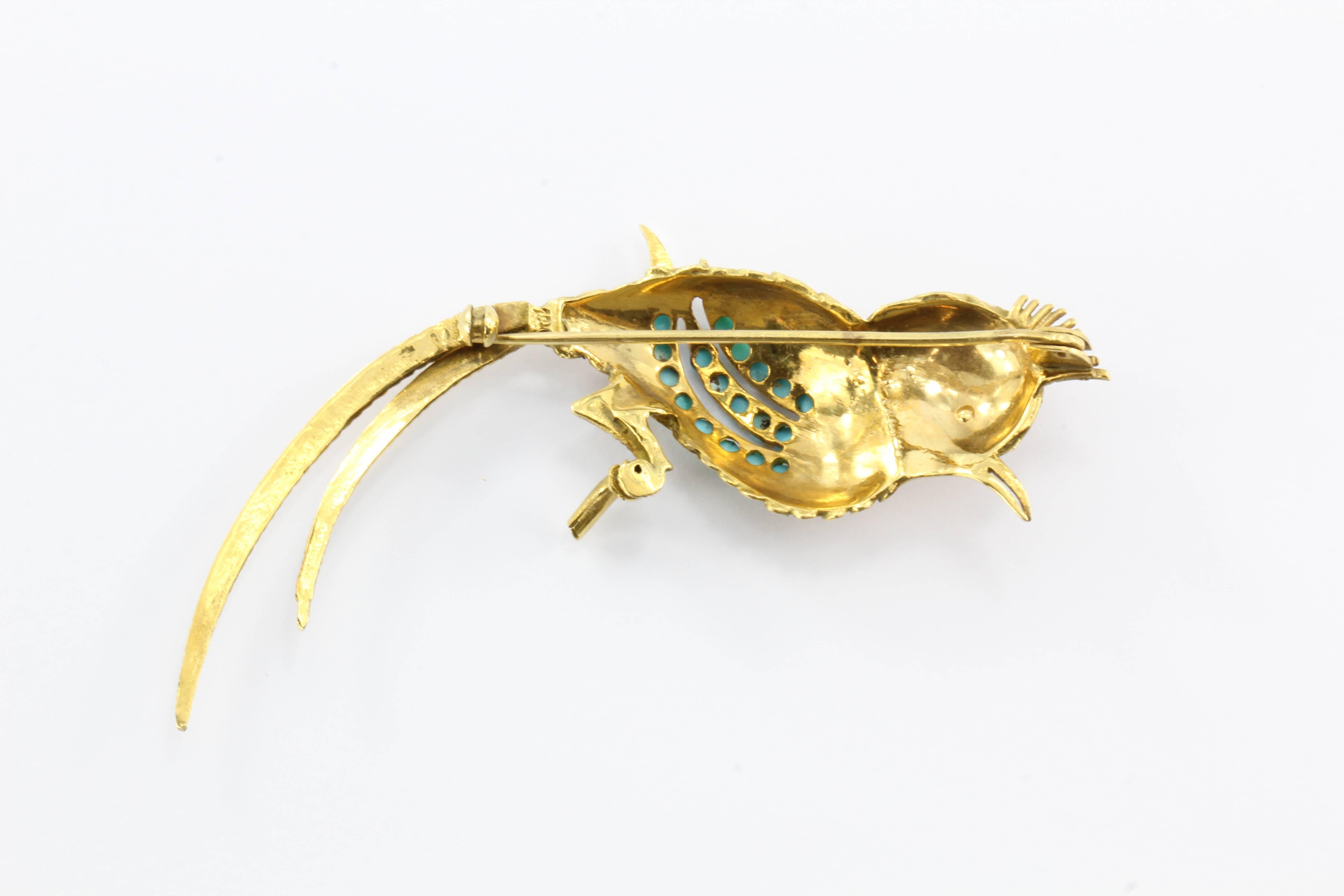 18K Gold Persian Turquoise Bird of Paradise Brooch. The piece is in great antique estate condition and ready to wear. The clasp for the pin closure is missing, though. It is hallmarked 18K. The piece is set with 18 cabochons of Persian turquoise. It