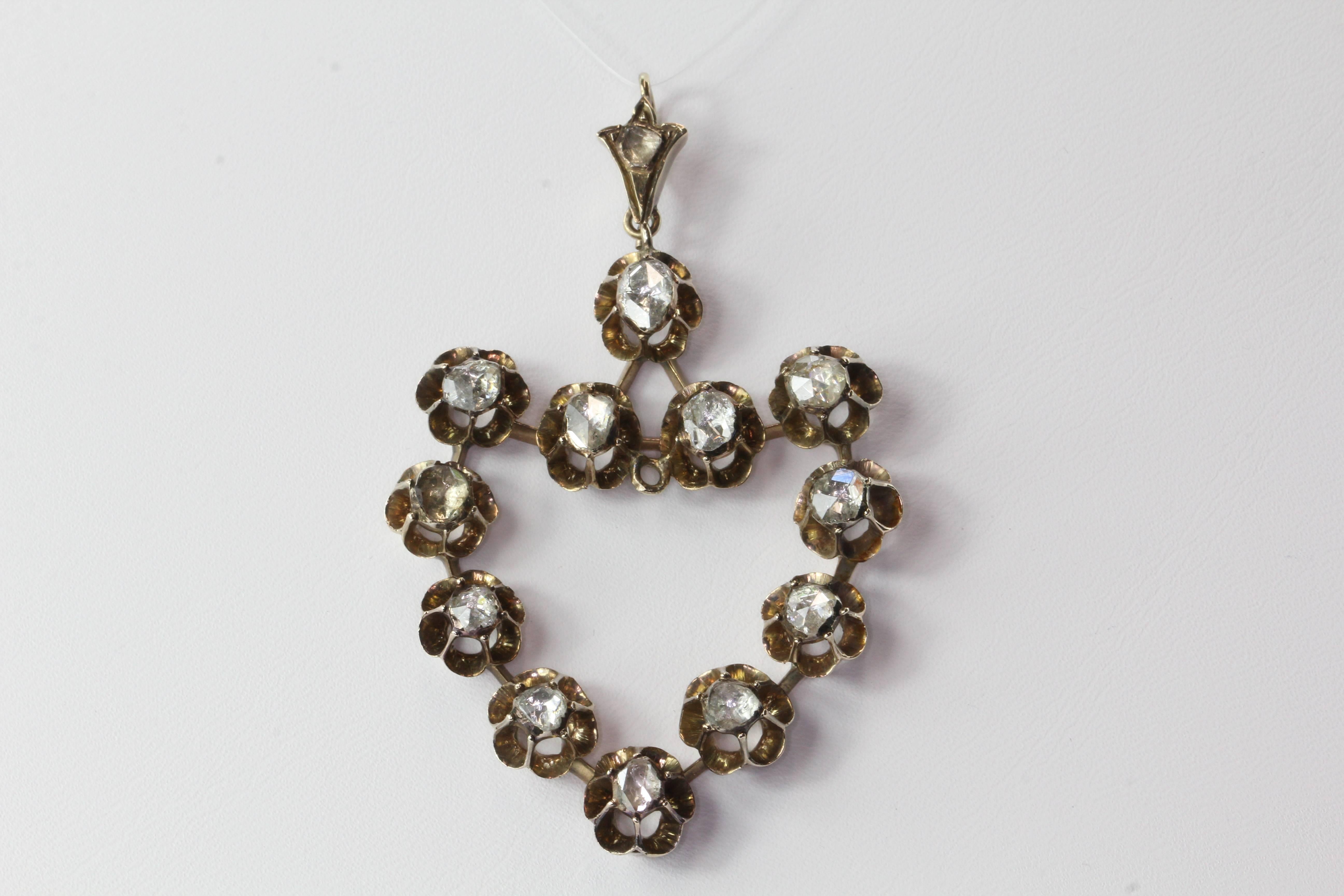 Victorian 10K Gold Rose Cut Foil Backed Diamond Large Heart Pendant Circa 1870's. The piece is in excellent estate condition and ready to wear. It is made of 10k yellow gold and set with 13 rose cut diamonds that measure around 5.68mm to 4.6mm. The