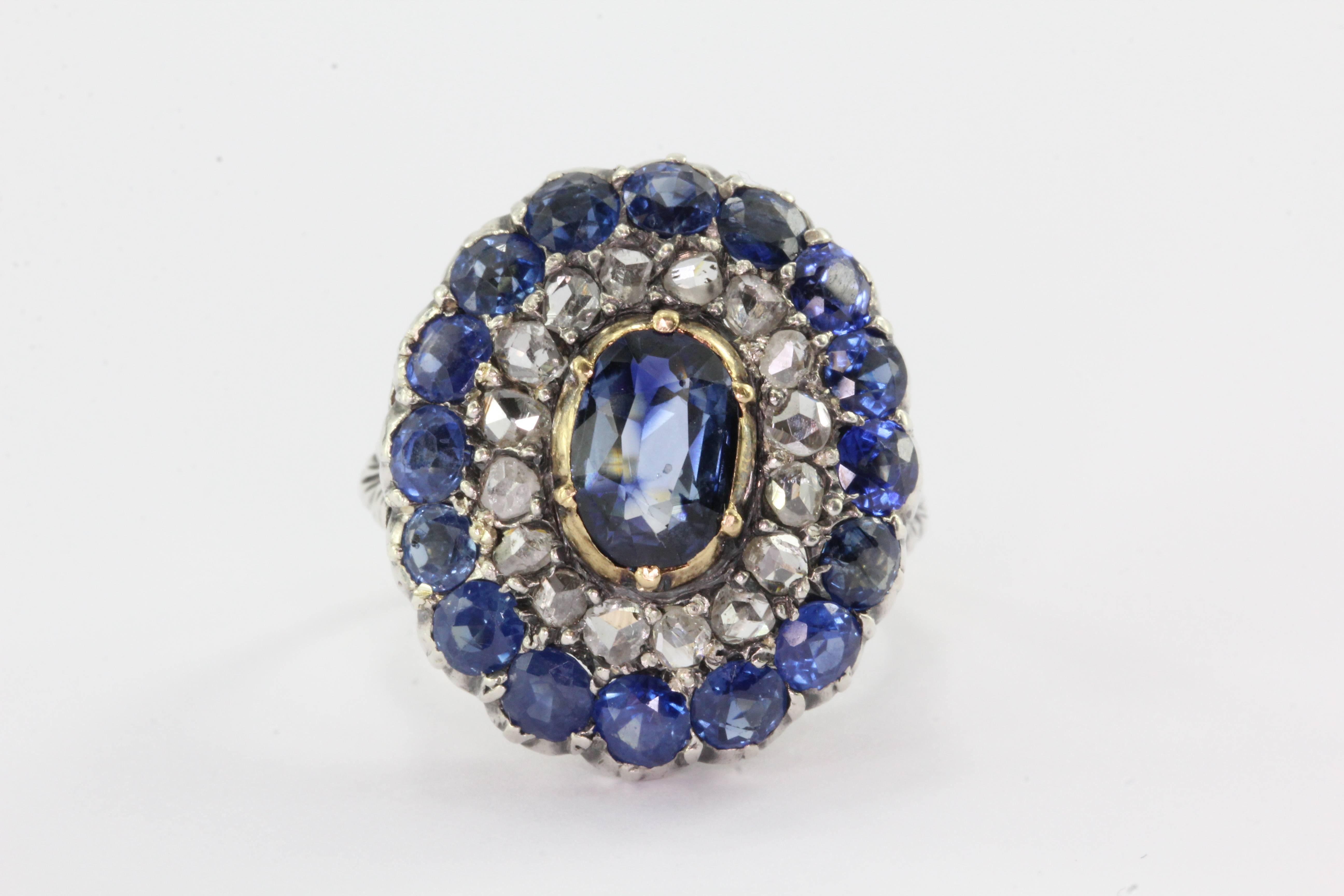 18K Gold Silver Top Blue Sapphire Rose Cut Diamond Ring. The ring is in excellent estate condition and ready to wear. Most of the ring is 18k yellow gold but the top is sterling silver. The center sapphire is approximately 1 carats with an