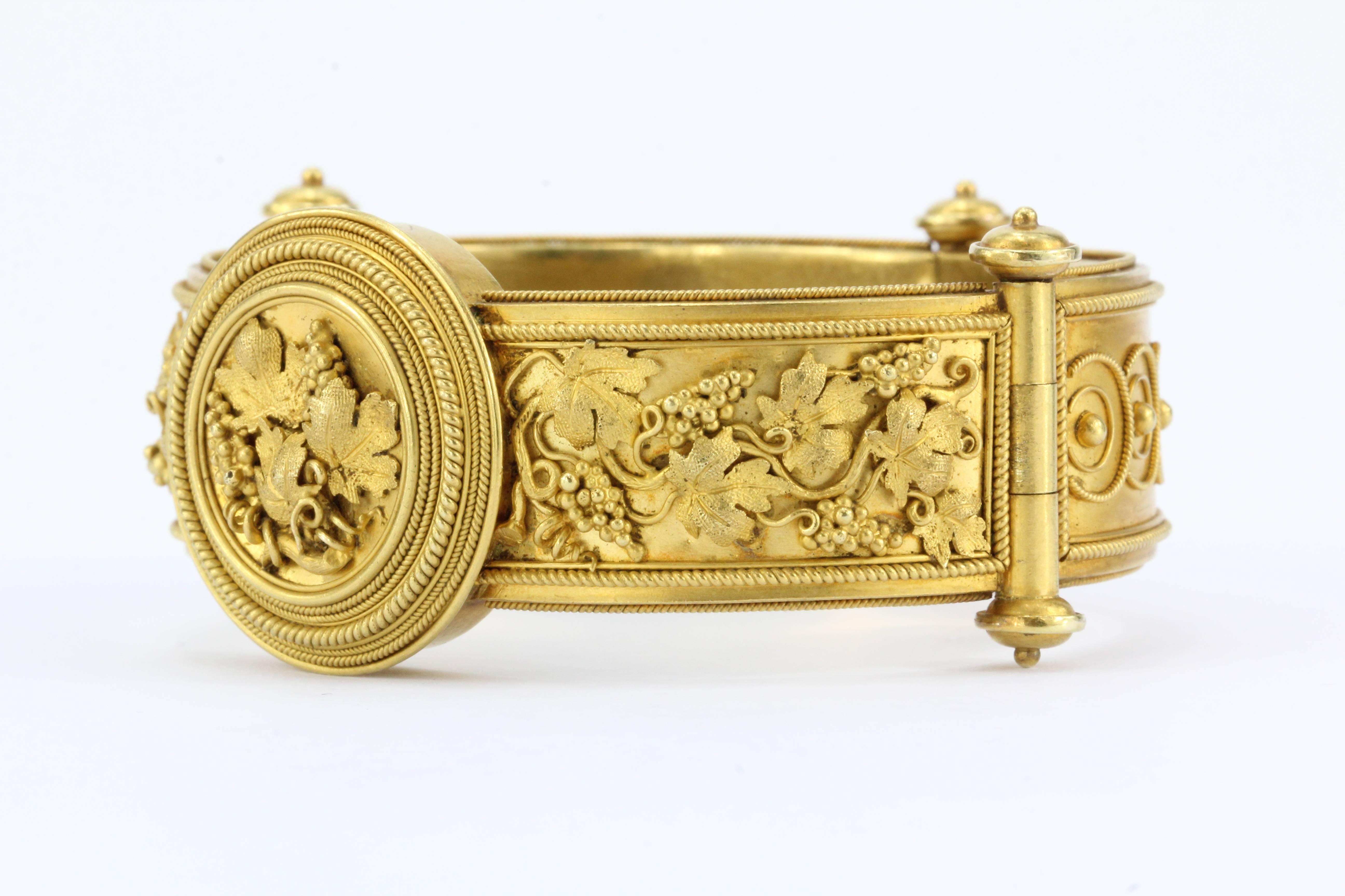 Victorian 22k Gold Etruscan Revival Grape Bangle Bracelet c.1870

Crafted with a workmanship not commonly seen outside of museums collections this bangle is in wonderful condition. The back has a hidden compartment that conceals a place to keep a