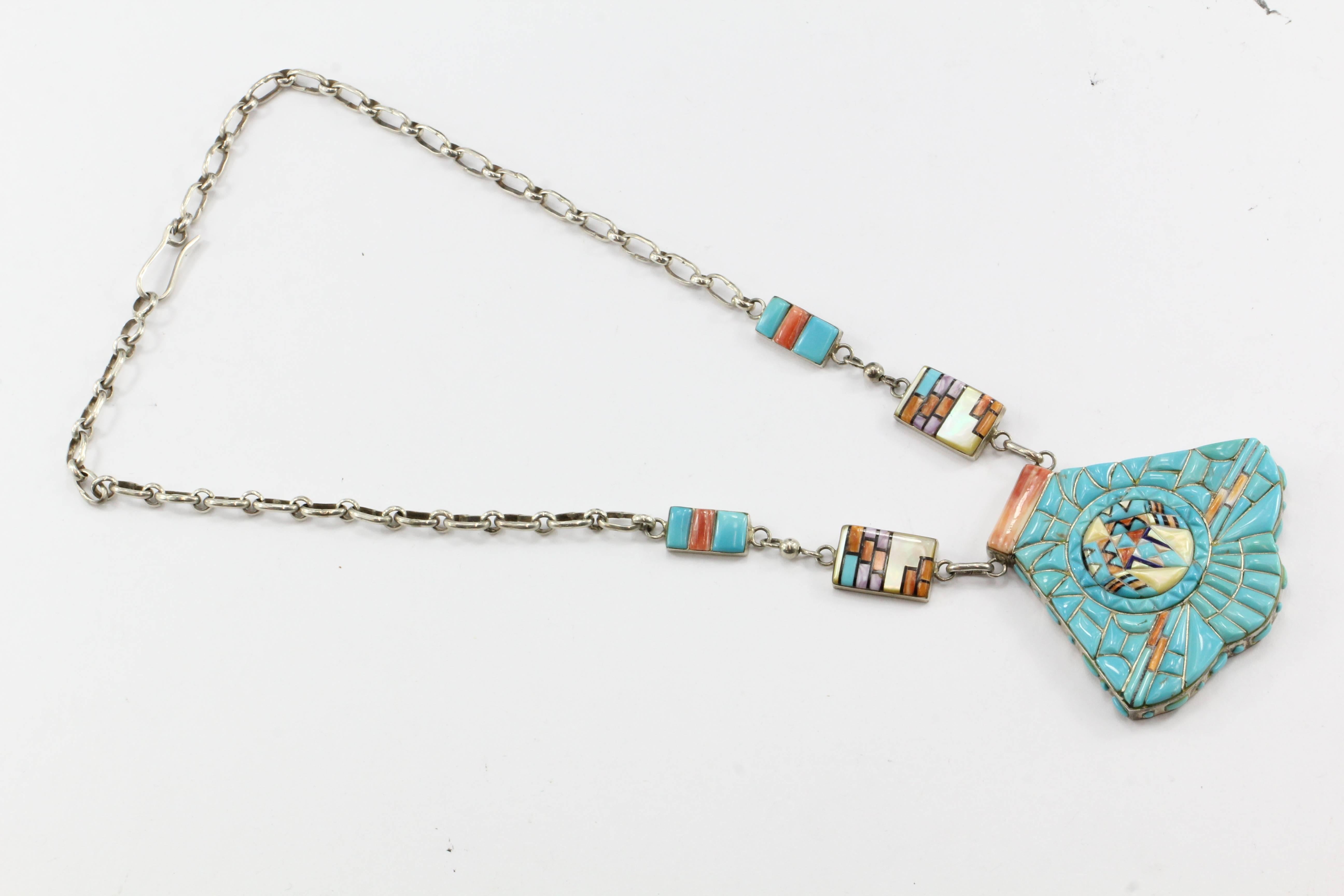 Zuni Sterling Silver Cobblestone Turquoise Inlaid Large Chunky Necklace

The necklace is in excellent estate condition and ready to wear. It is made of sterling silver and inlaid with primarily turquoise but also with spiny oyster, jet, mother of