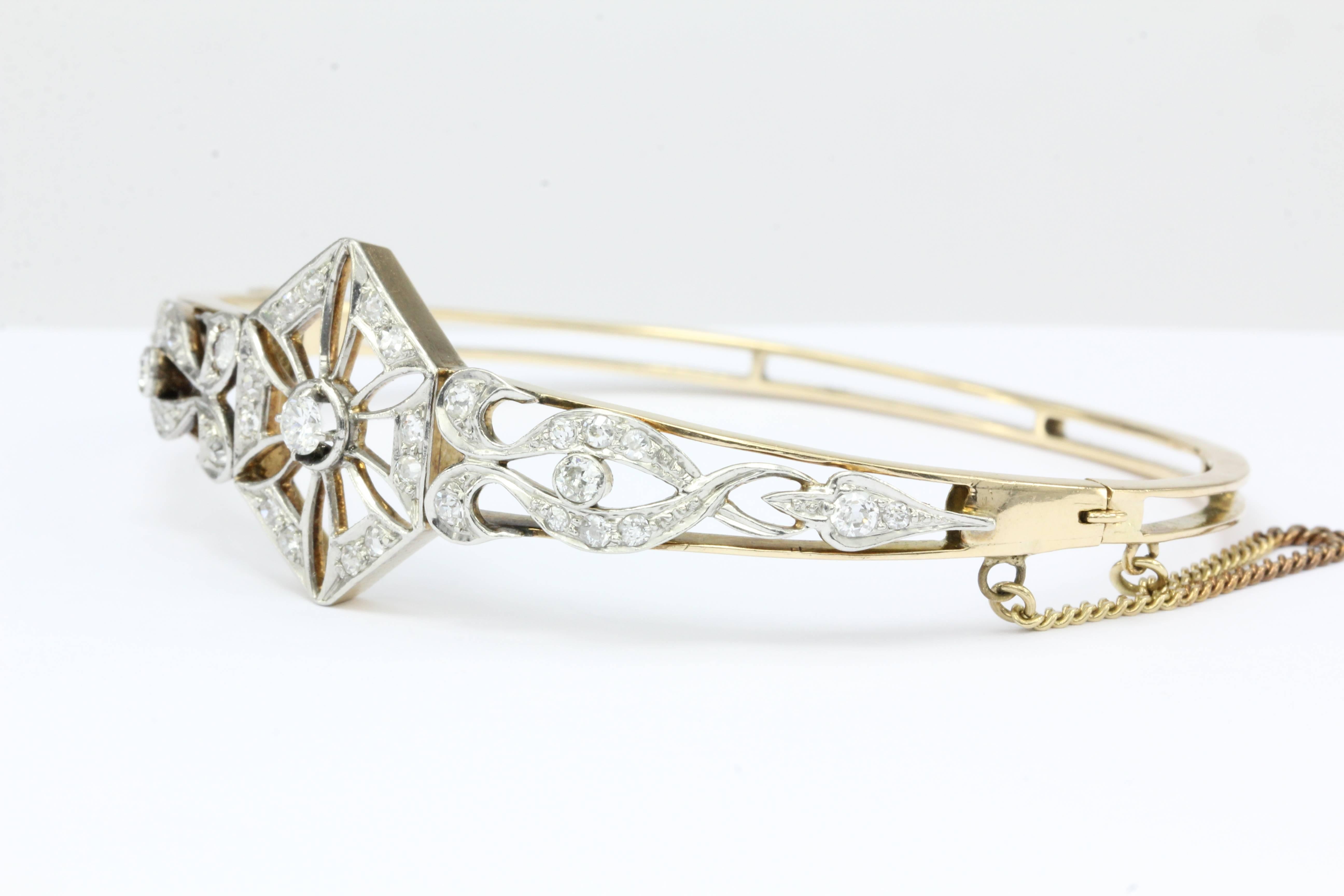  Art Deco 14K Yellow Gold Old European Cut Diamond Bangle Bracelet c.1920

A delicate art deco sparkling diamond snowflake appears to be tossed by opposing east & west winds as this magical scene plays out atop this stunning bracelet. The piece