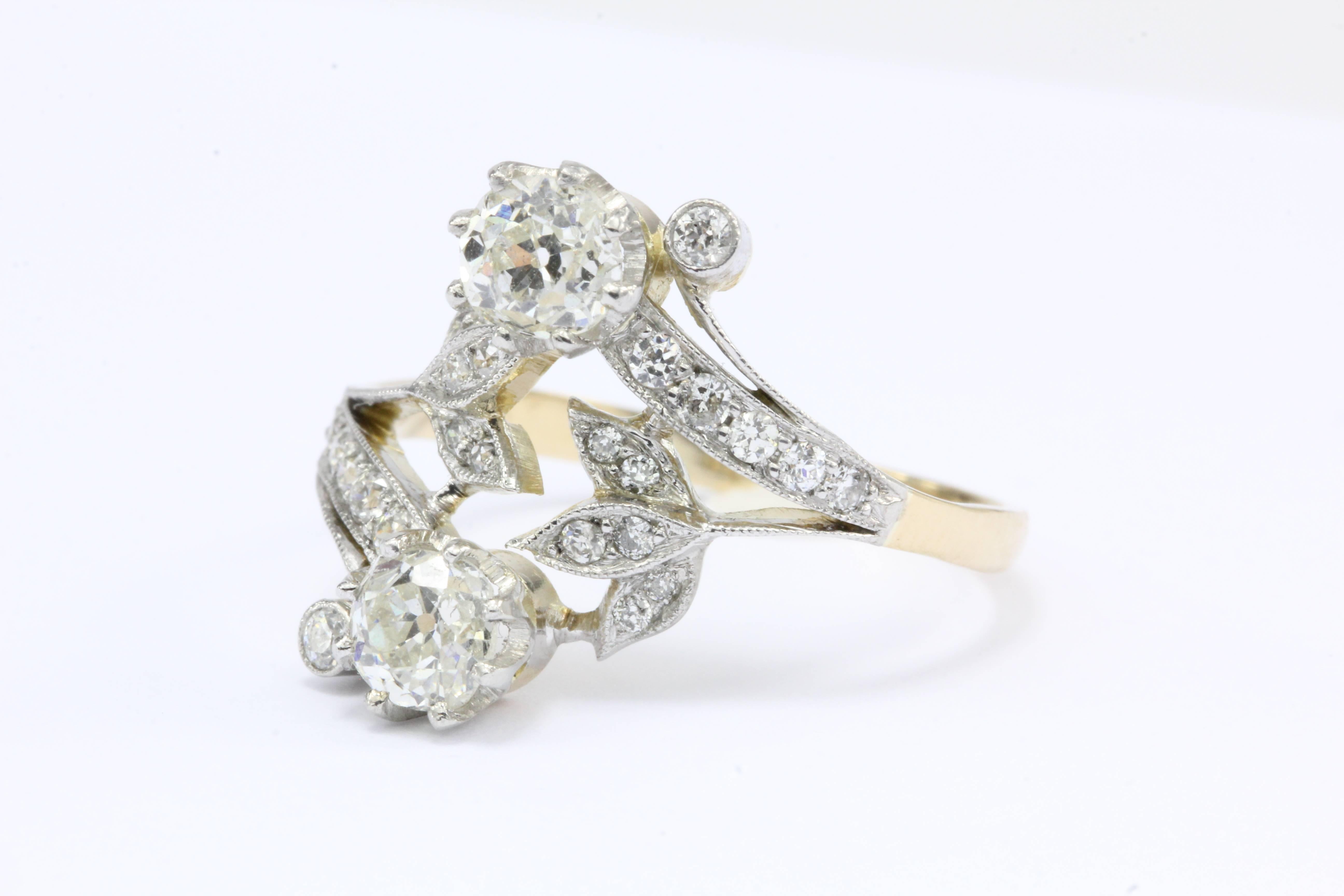 Edwardian Old Mine Diamond 18K Gold Floral Motif Ring

A matching pair of platinum set diamond flowers waltz around each other waiting to embrace on this 18k yellow gold engagement ring. The ring is mostly 18k yellow gold but the diamonds are set in