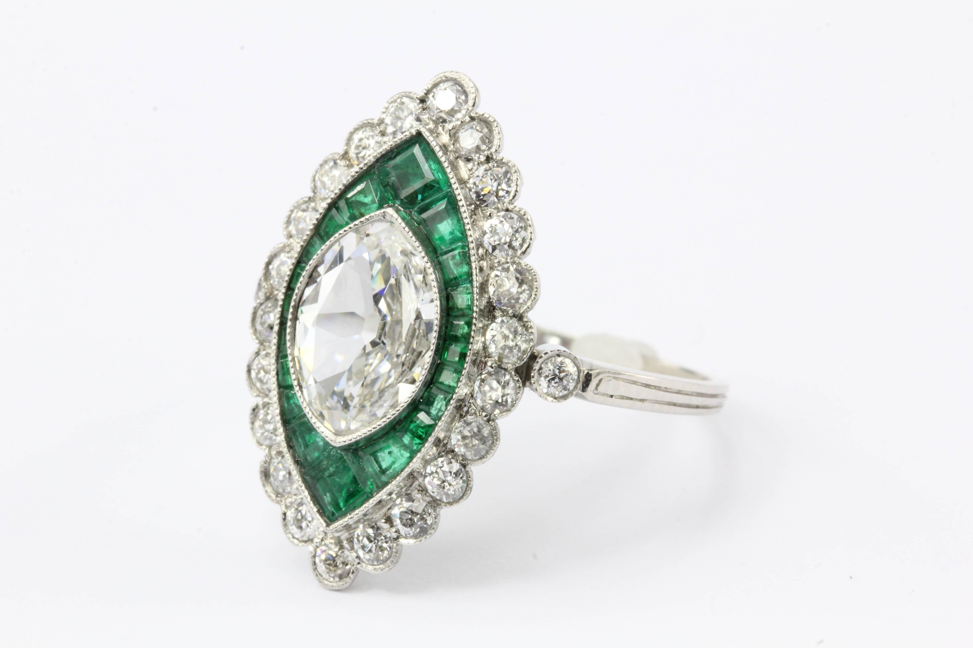  Platinum 1.05 Carat Moval Diamond & Emerald Halo Engagement Ring

This 1.05 carat Moval cut diamond lies as comfortably between its frame of emeralds as a summer rain drop rests upon a lush green rose leaf. The center 1.05 carat Moval cut