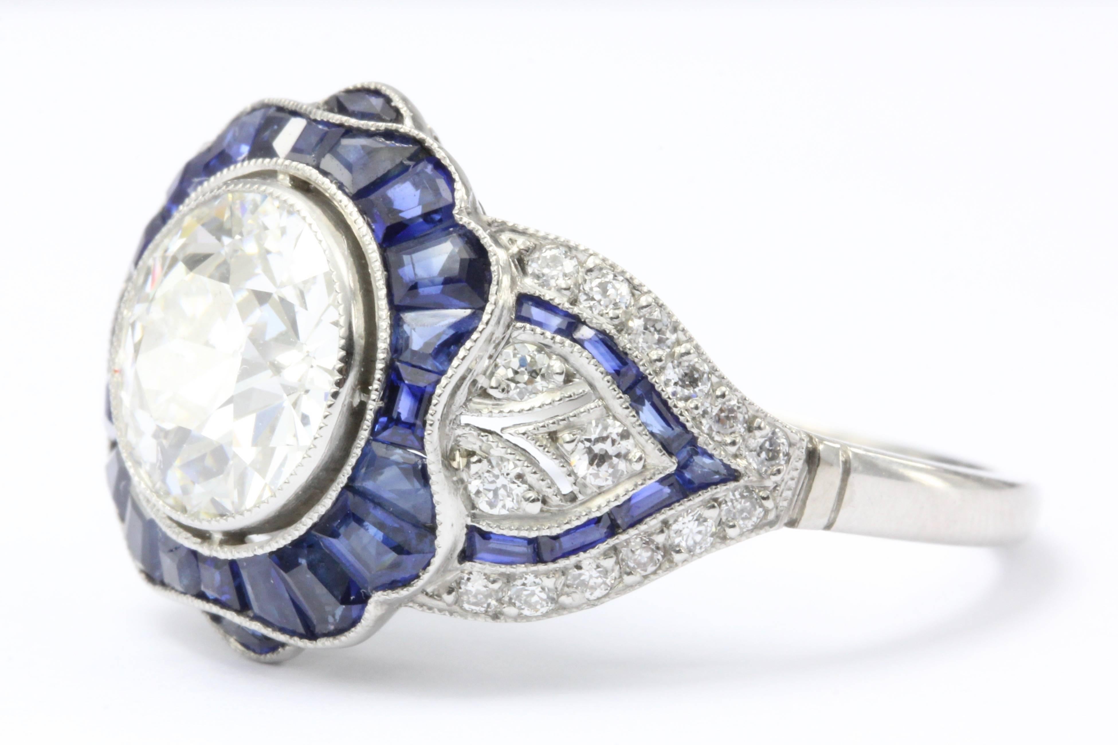A fabulous handmade Art Deco style piece based on an Art Deco beauty. This lovely platinum ring features calibre cut natural blue sapphires, accent diamonds, and a gorgeous GIA certified 2.07 carat old European cut diamond in the center. 

Main