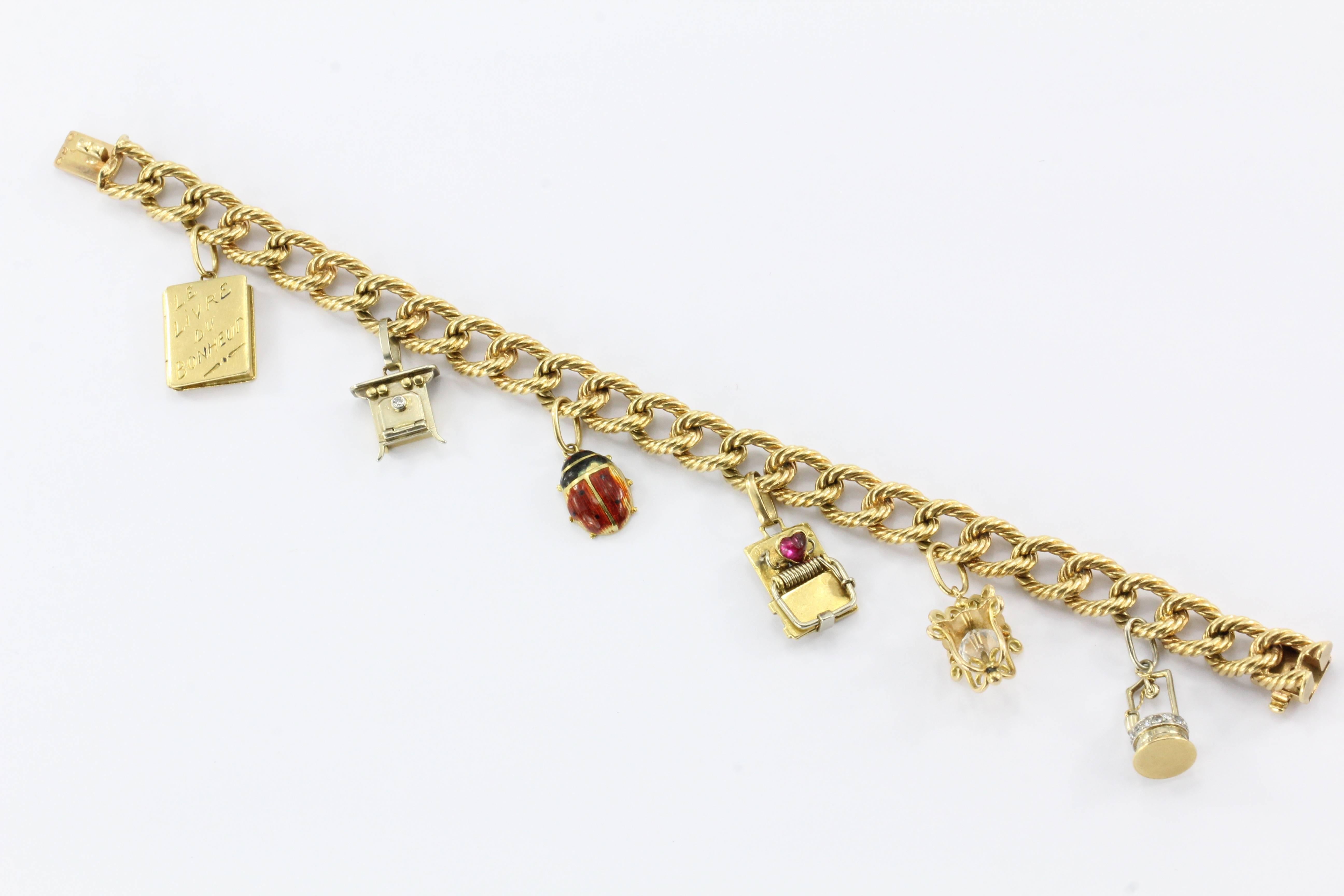 Cartier 18K Gold French Retro Loaded Charm Bracelet c.1950's

This charming Cartier bracelet comes complete with 6 gold charms. It is signed Cartier as well as the French Eagle head marks for 18K gold and a blurred French mark. The piece measures