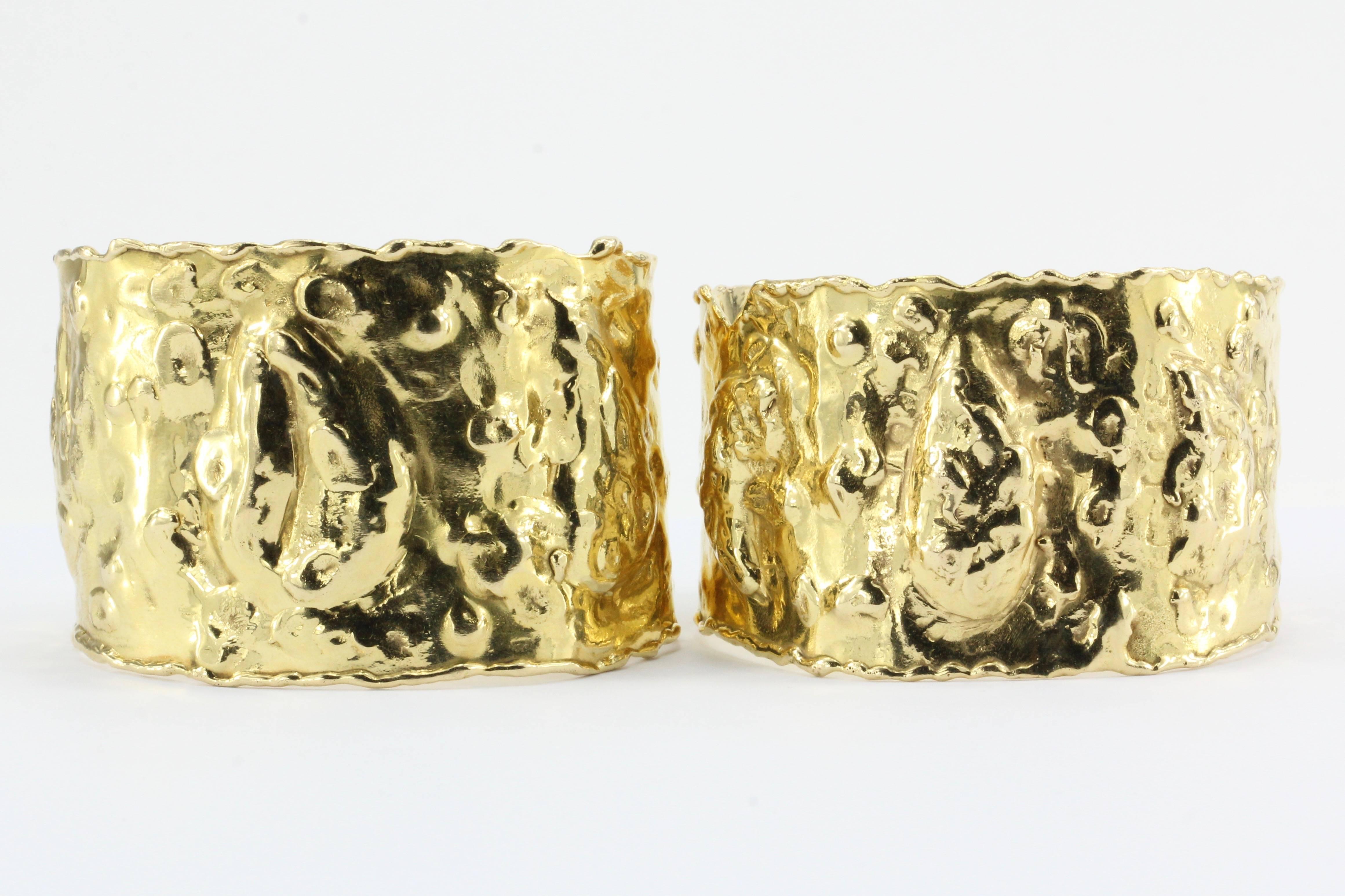 Van Cleef & Arpels 18K Gold Jackie-O Manchette Cuff Bracelets Pair c.1970

Inspired by the goldsmith work of Ancient Greece and made famous by style icon Jacqueline Kennedy Onassis when she first wore them in public in 1977. Each cuff is in