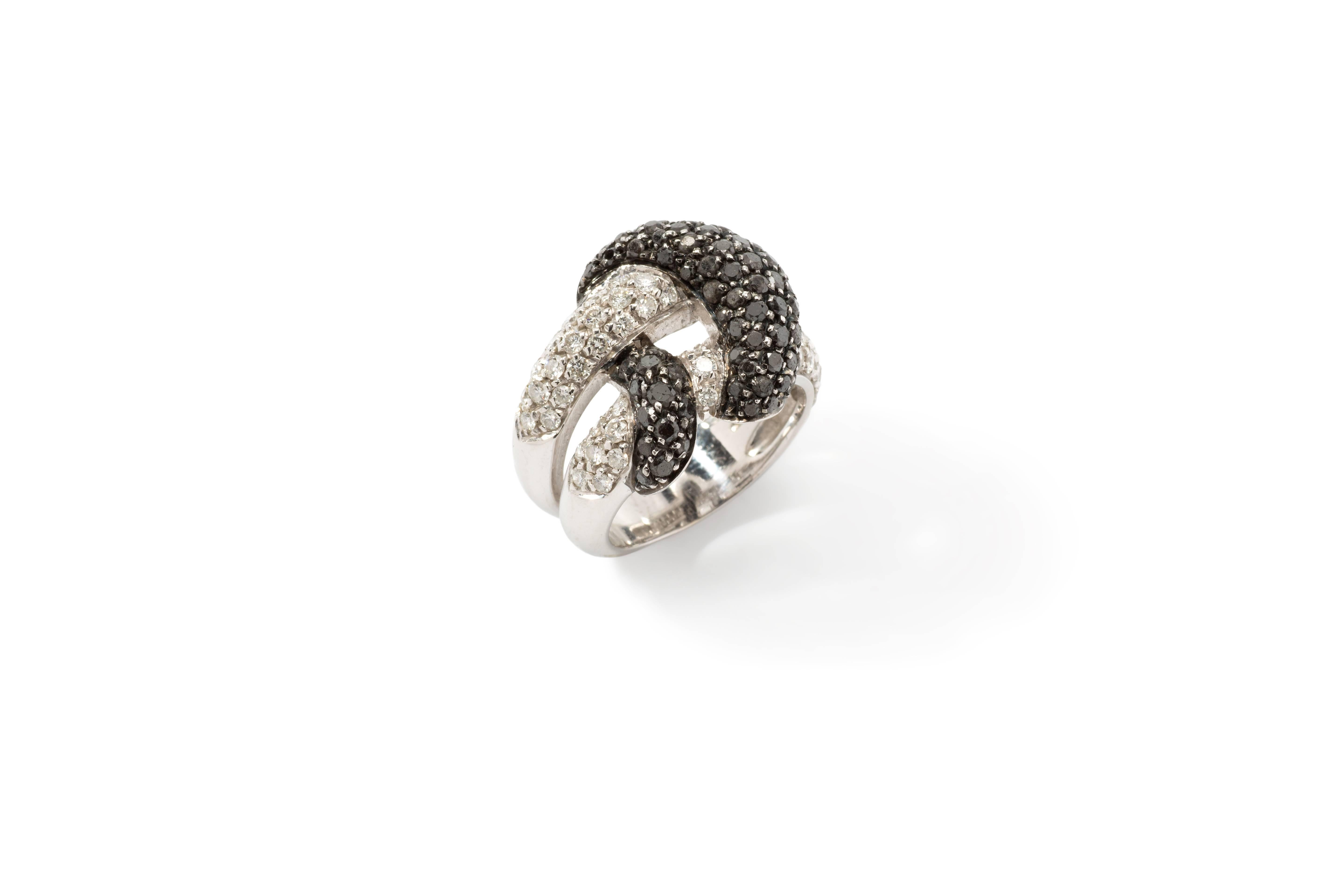 Pavé-set with circa 70 black brilliant-cut diamonds and 59 brilliant-cut diamonds weighing approximately 3,30 ct. Mounted in 18K white gold. Total weight: 12,04 grams. Width: 0.71 ( 1,8 cm ). Ring size 53 ( US 5,5 ). Resizable