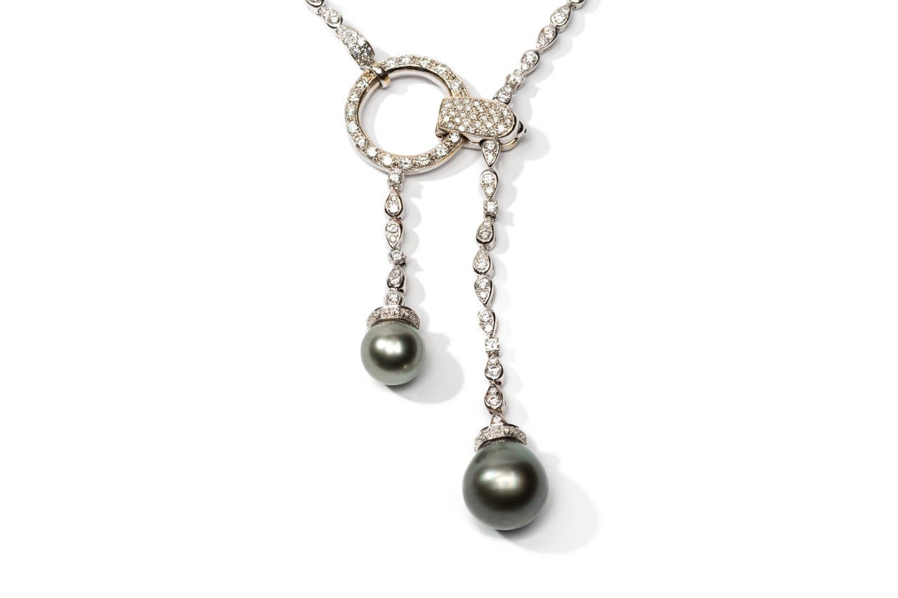 Set with 236 diamonds weighing approximately 8,712 carats and 2 grey tahitian cultured pearls with a diameter of ca 10- 16mm, good luster. Mounted in 18K white gold. Hallmarked: 750CO 41 6909 and signed: Boucheron. Weight: 55,99 g., Length: 9.65 in