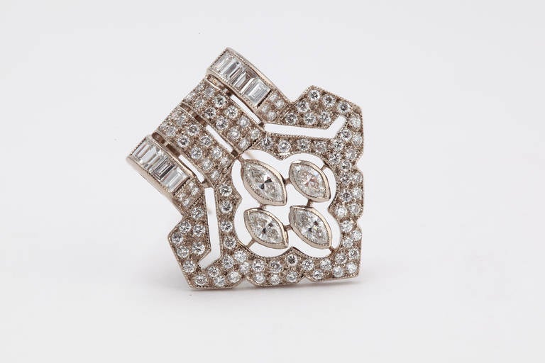 Art Deco design with 178 old-mine-cut diamonds, 8 marquise-cut diamonds and 16 baguette-cut diamonds with a total weight of circa 1,11 ct. Mounted in white gold. Millegrain setting. Weight 5,31 g. 
Height: 0.98 in ( 2,5 cm ), Width: 0.91 in ( 2,3 cm