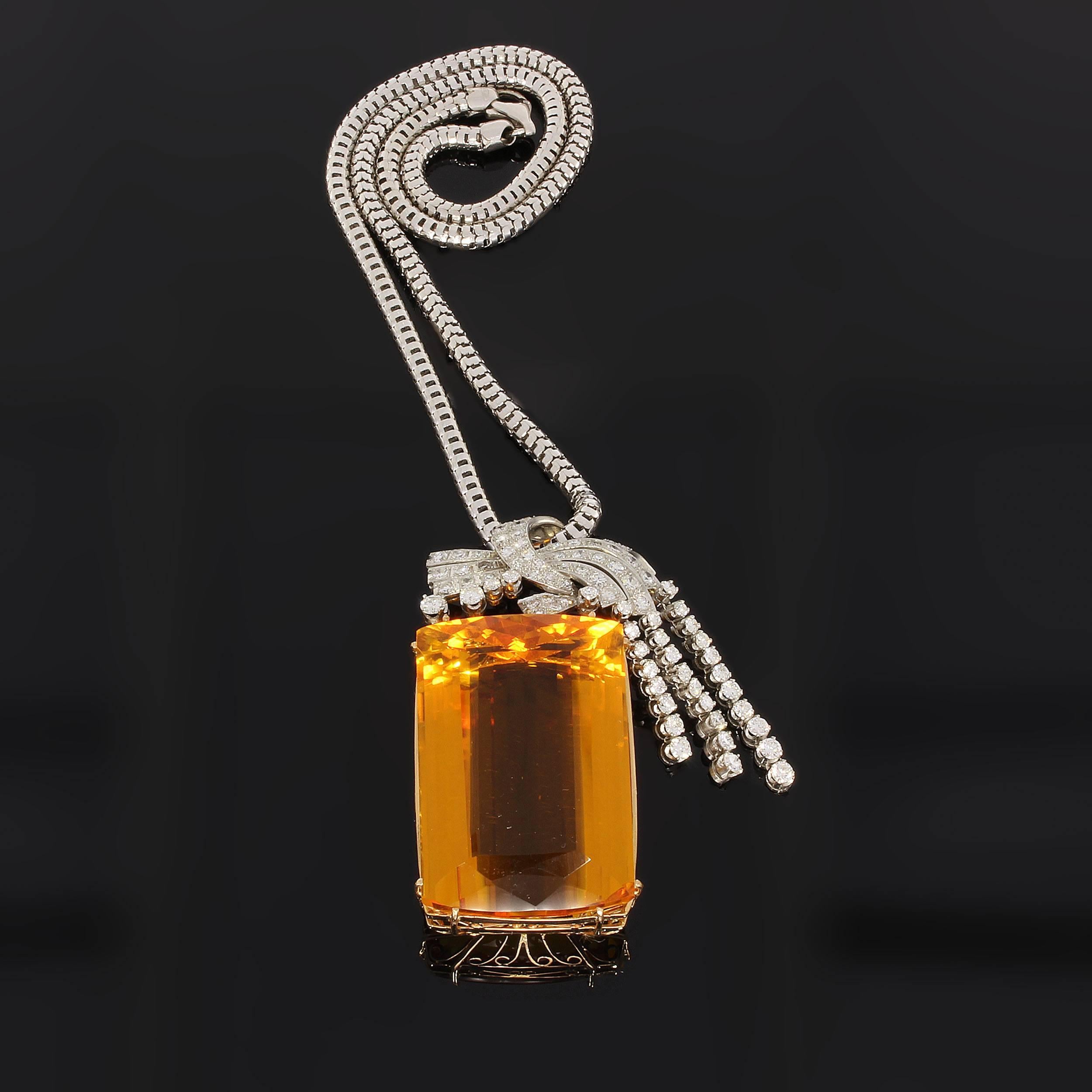 Emerald-cut citrine in beautiful colour, 1.81 x 1.16 in ( 46,01 x 29,52 mm ), Height 0.64 in ( 16,23 mm ) decorated with 84 brilliant-cut diamonds weighing 4.28 carats. White gold chain with carabiner closure. Hallmarked with 750. 
Total weight 77,8