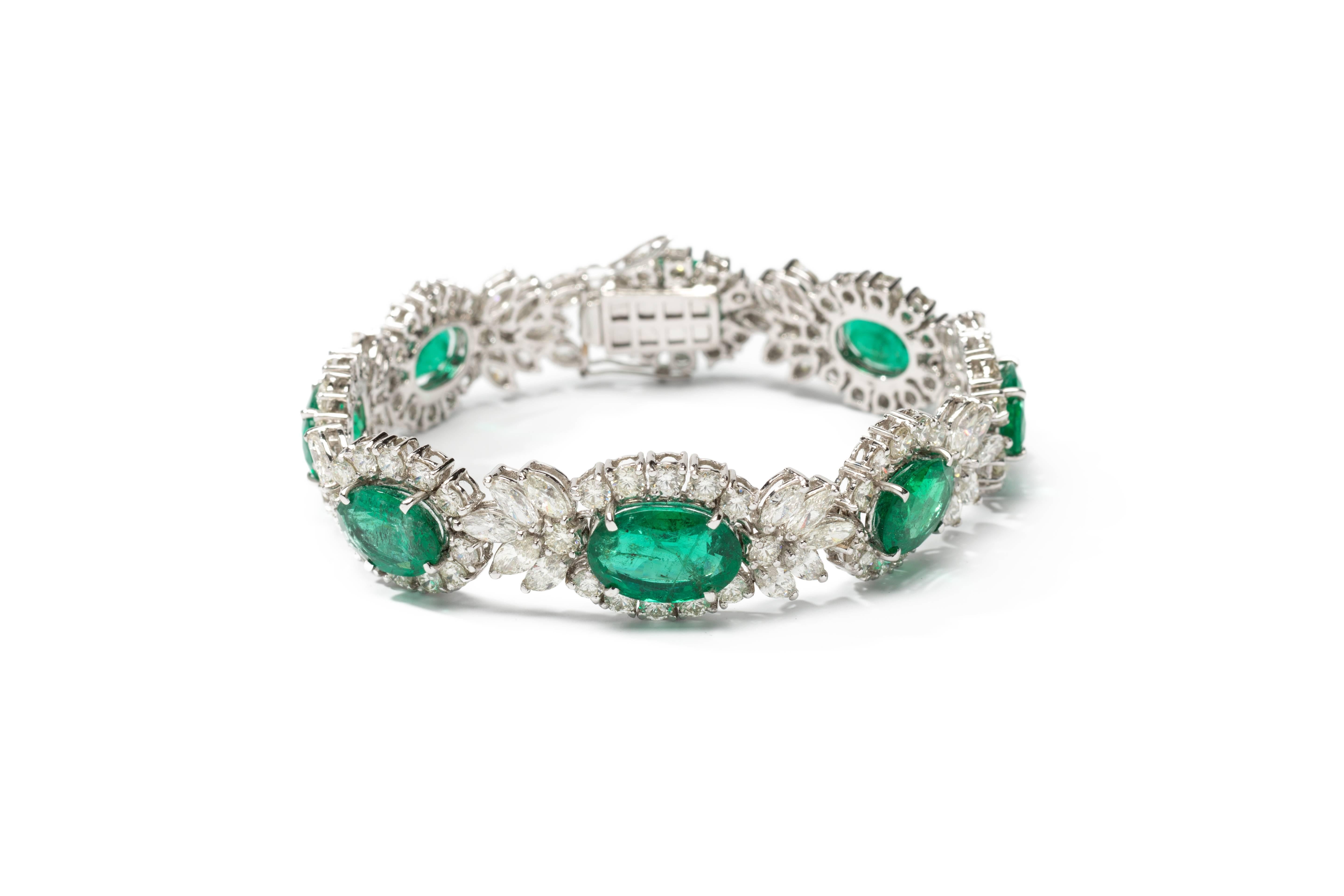 1950's-1960's. Set with 8 oval-shaped emeralds with a total of circa 21,88 carats, 131 diamonds in brillant-cut and navette-cut weighing circa 13,54 carats. Mounted in 18K white gold. Weight 34,2 g. 
Length: 7.28 in ( 18,5 cm ), Width: 0.59 in ( 1,5