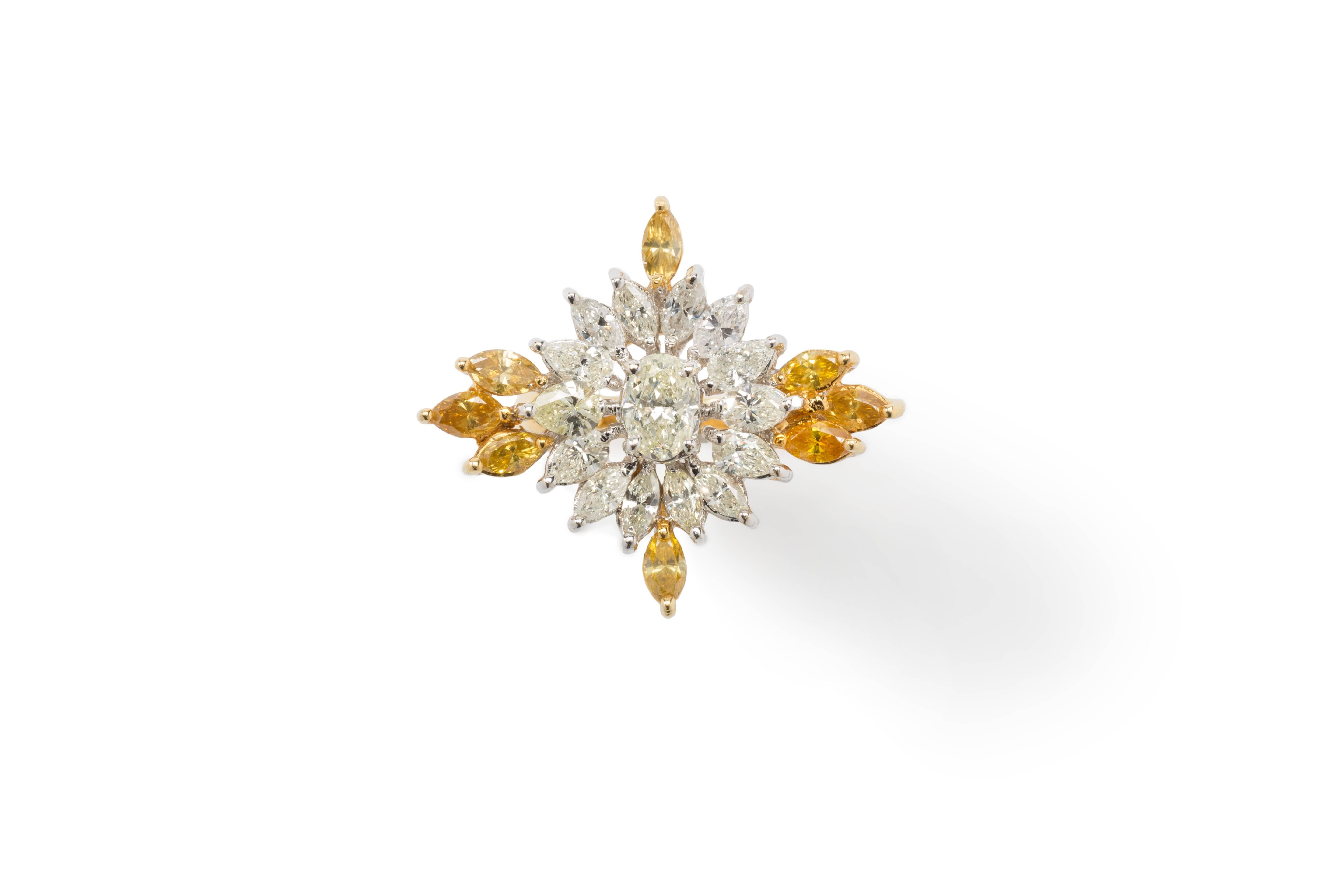 Oval shape diamond weighing circa 0,88 ct., framed by 14 navette-cut diamonds weighing circa 1,96 ct. and adorned with 8 navette-cut diamonds weighing circa 1,39 ct., color: fancy yellow intense. Mounted in 18K yellow gold. Marked with the purity