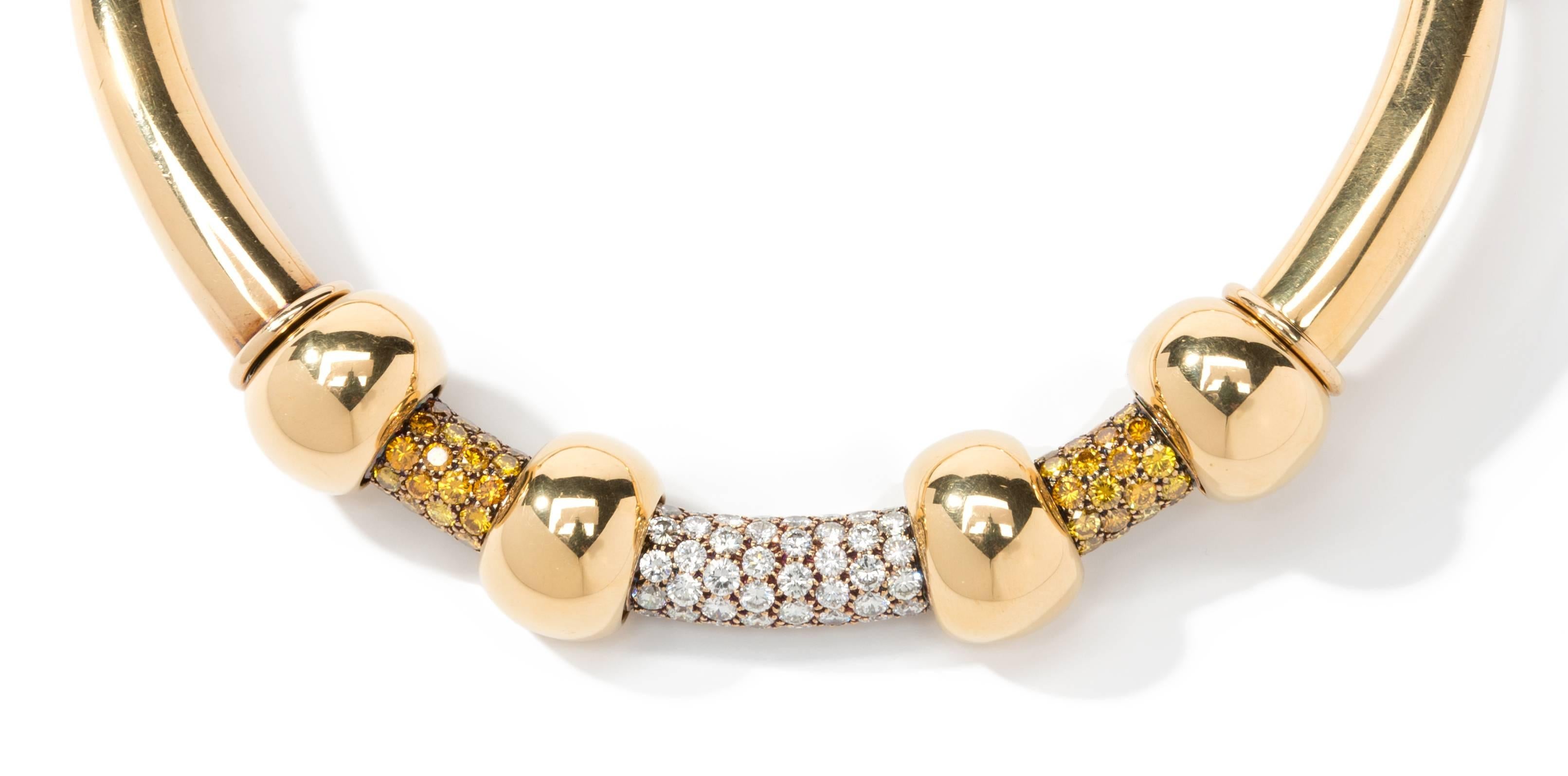 Torc design by Renè Boivin, Paris 1970. The front set with three diamond frontal panels with gold rondelle spaces. 
With 53 fancy brown yellowish and 46 fine white brilliant-cut diamonds. Weight ca. 10,91 ct. Mounted in 18K yellow gold. Signed: