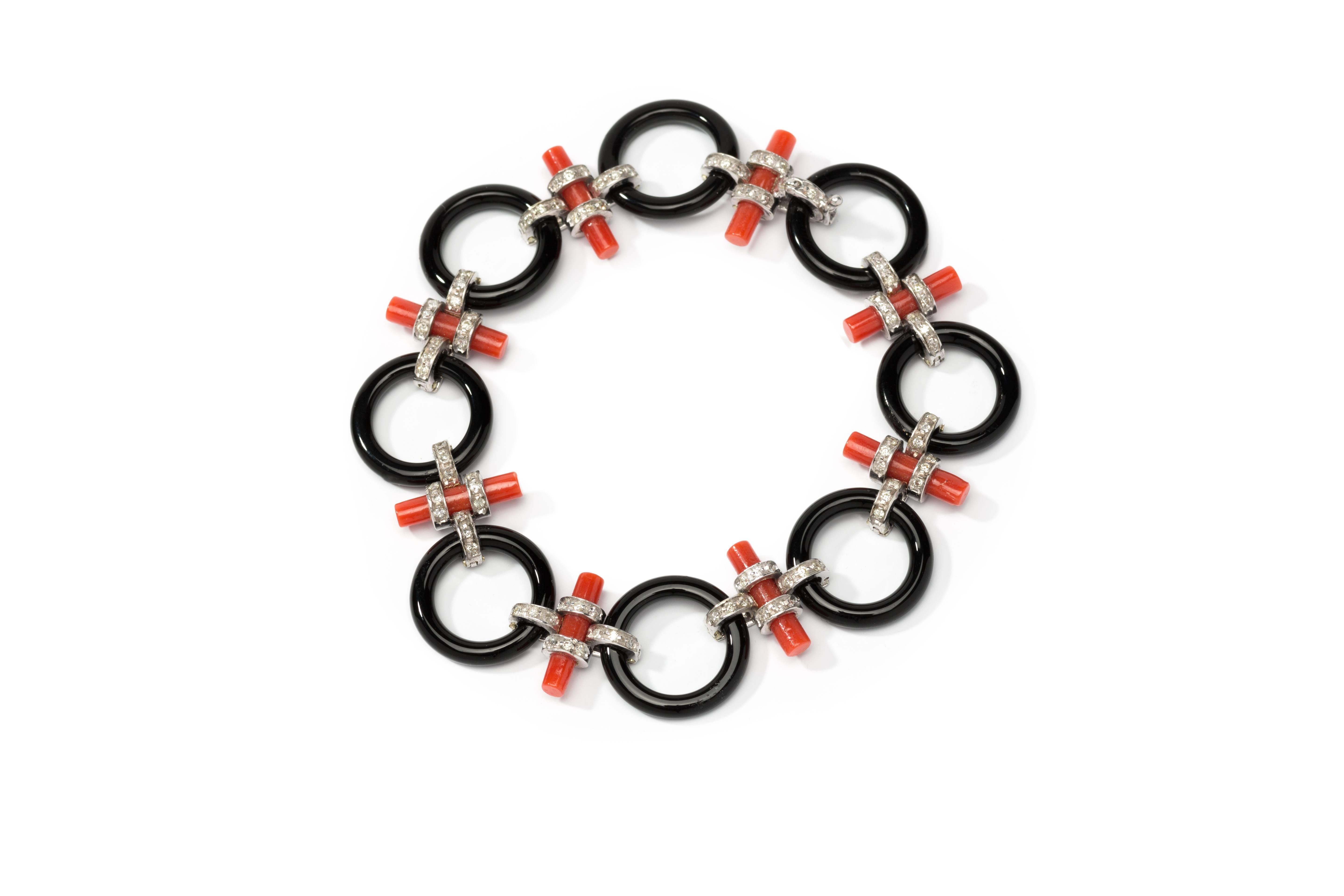 Italy, 1970's. Set with 8 rod shaped coral and 8 onyx circle connected and decorated with 93 brilliant-cut diamonds weighing approximately 1,0 ct. Mounted in 14 k white gold. Total weight: 16,88 grams. 
Length: 7.48 in ( 19 cm ), Width: 0.67 in (
