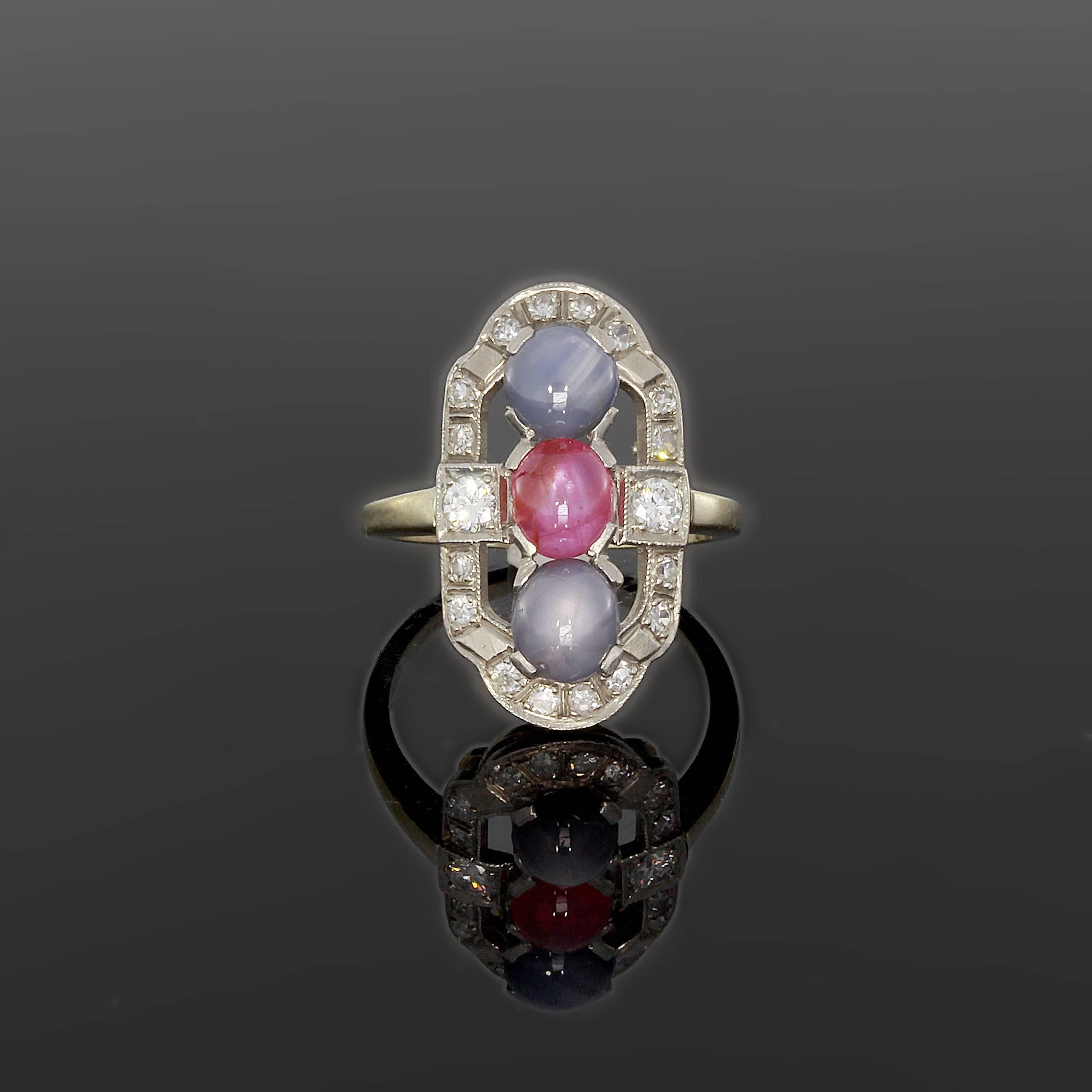 France, 1920s. 2 star cabochon-cut sapphire, 1 cabochon-cut star ruby and 18 brilliant-cut diamonds (Tot. 0.48ct.) Mounted in 14K white gold with millegrain setting. Hallmarked inside: 14K PALL Total weight: 4,66 g. Height: 0.98 in ( 2,5 cm ),