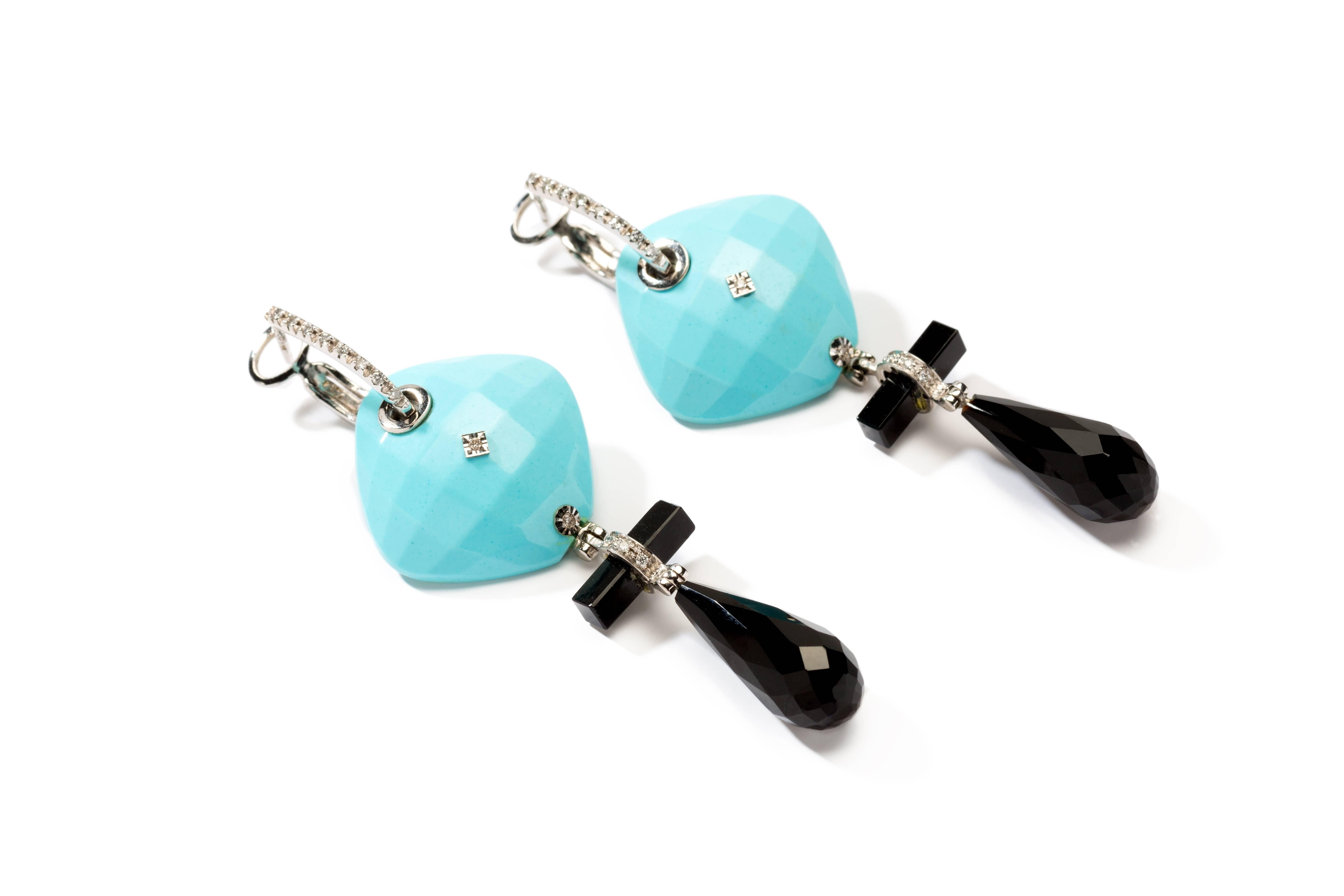 Italian design, 1970's. Set with 2 rectangular turquoise, 2 pear shaped onyx and 2 rod shaped onyx. Decorated with 28 brilliant-cut diamonds weighing ca. 0,19 ct. Mounted in 18 K white gold. Each earring hallmarked on a yellow gold badges with