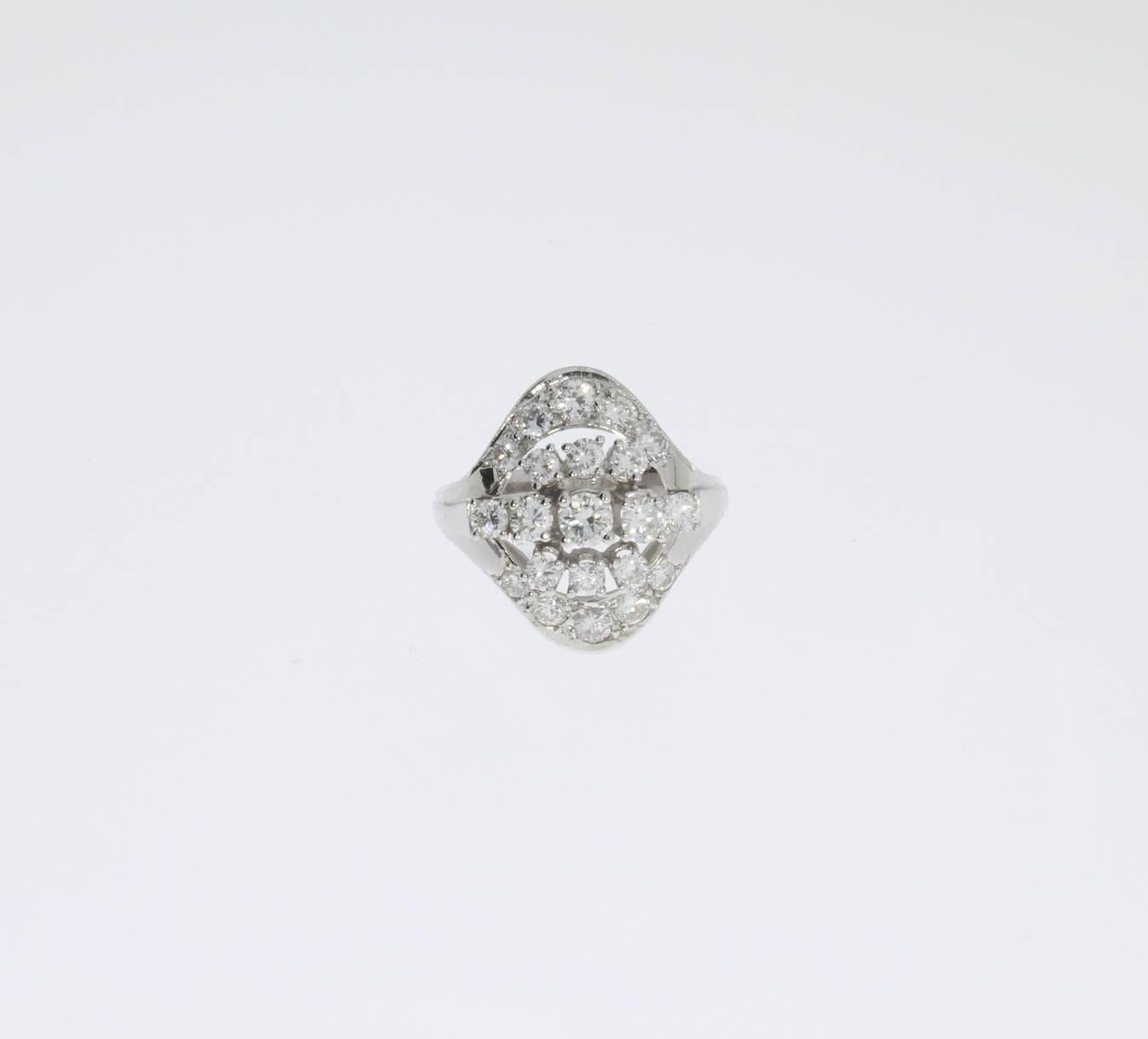 Europe, 1950's. Composed of 21 brilliant-cut diamonds weighing approximately 1,42 ct. Mounted in 14 K white gold. Hallmarked inside with a fineness 585. Weight: 5,4 g. Dimensions: circa 0.79 x 0.67 ( 2 x 1,7 cm ). 
Ring size: 57 ( US 7 3/4 ).