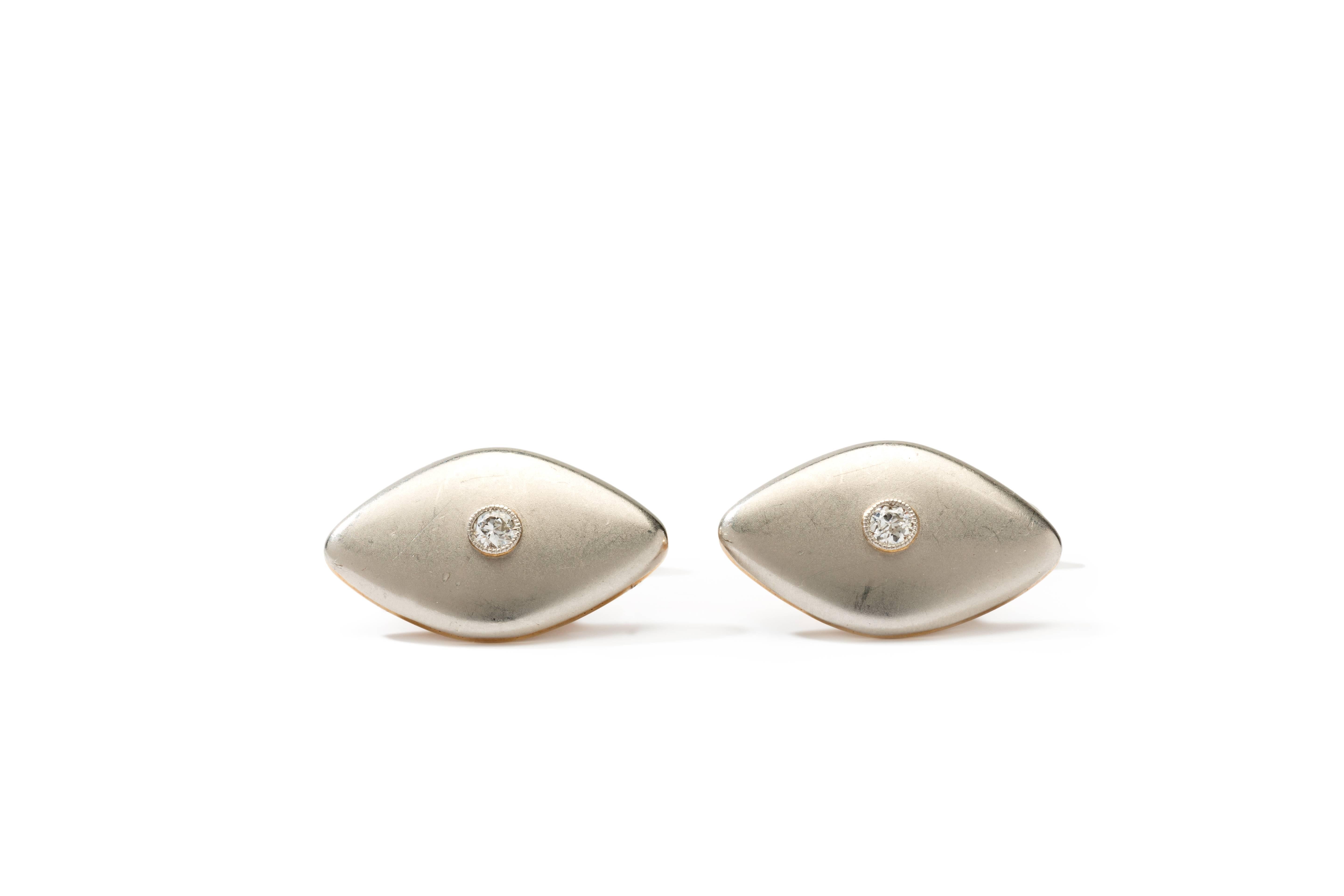 Elongated eye shaped cufflinks accented by 2 brilliant-cut diamonds with a total weight of 0,20 ct. 
Crafted in 14 K yellow gold and platinum. Hallmarked with the purity 585. Total weight: 9,42 grams. 
Measurements: 0.55 x 0.87 in ( 1,4 x 2,2 cm )