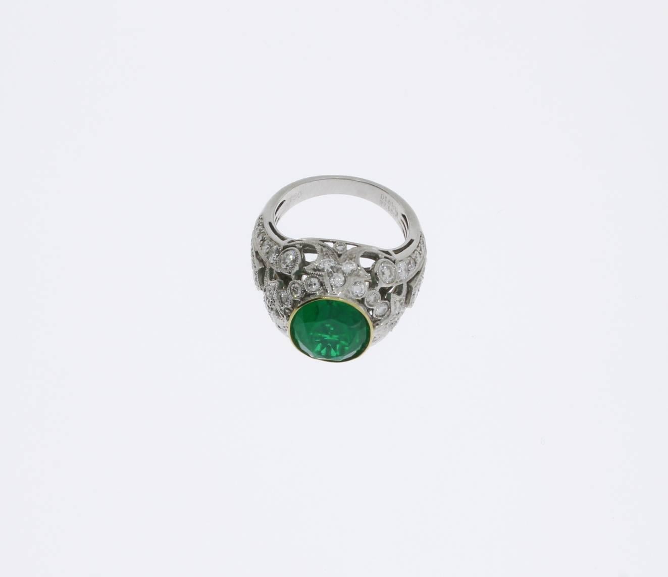 Europe, 1960s-1970s. In Art Deco style. This ladies ring of 18 karat white gold shows an oval shaped Brasilian emerald of 10,30 carat complemented by numerous brilliant-cut diamonds weighing 1,61 ct. Openwork, millegrain setting. Hallmarked inside