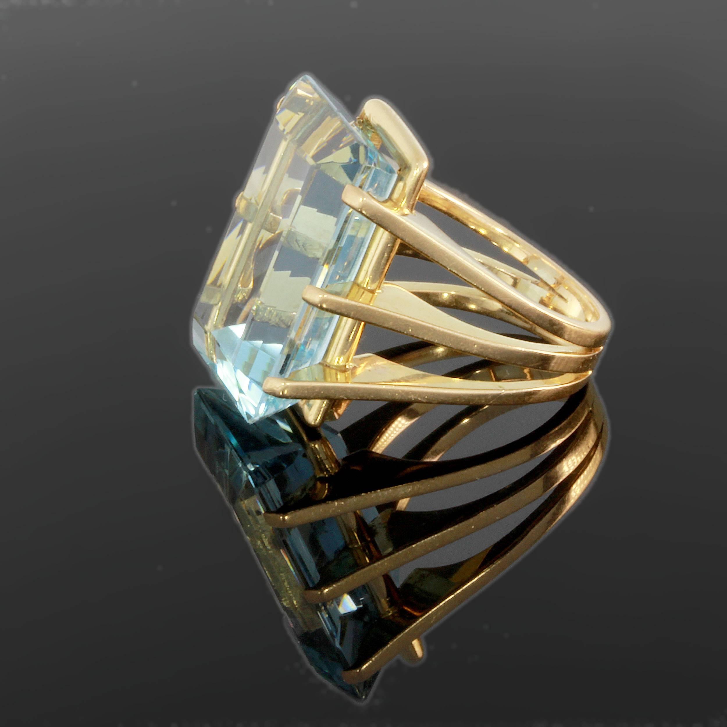 1940s. Set with emerald-cut, 20 ct. Brazilian aquamarine. Mounted in 18K yellow gold. Total weight: 20,47 grams. 
Measurements: 0.98 x 0.71 x 0.43 in ( 2,5 x 1,8 x 1,1 cm ). Ring size: 56 ( US 7 1/2 ) Resizable.
