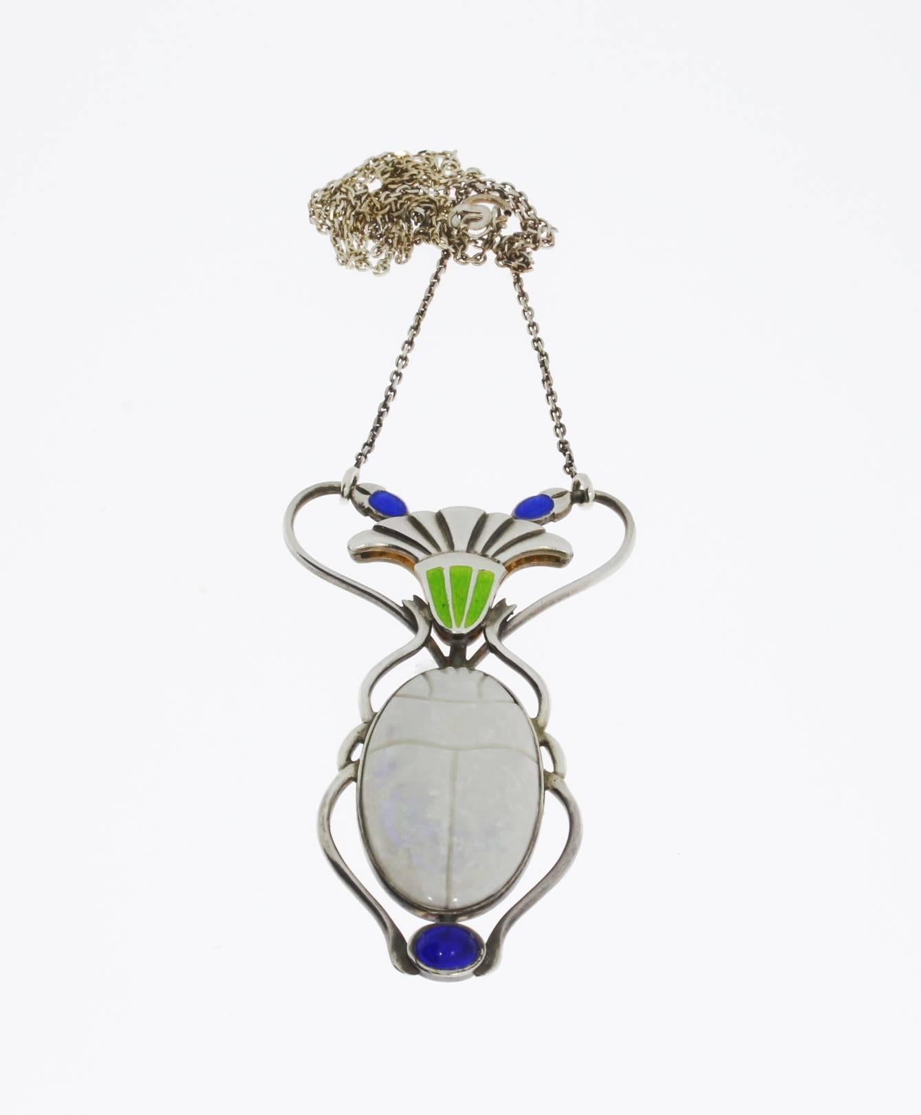 This Art Nouveau silver pendant was crafted about 1900. Studded with oval opal in scarab shape and enameled. Hallmarked on the back: DEPOSE, 900 and maker`s mark. The pendant comes with a silver chain. Total weight: 11,12 g. Pendant measurements: