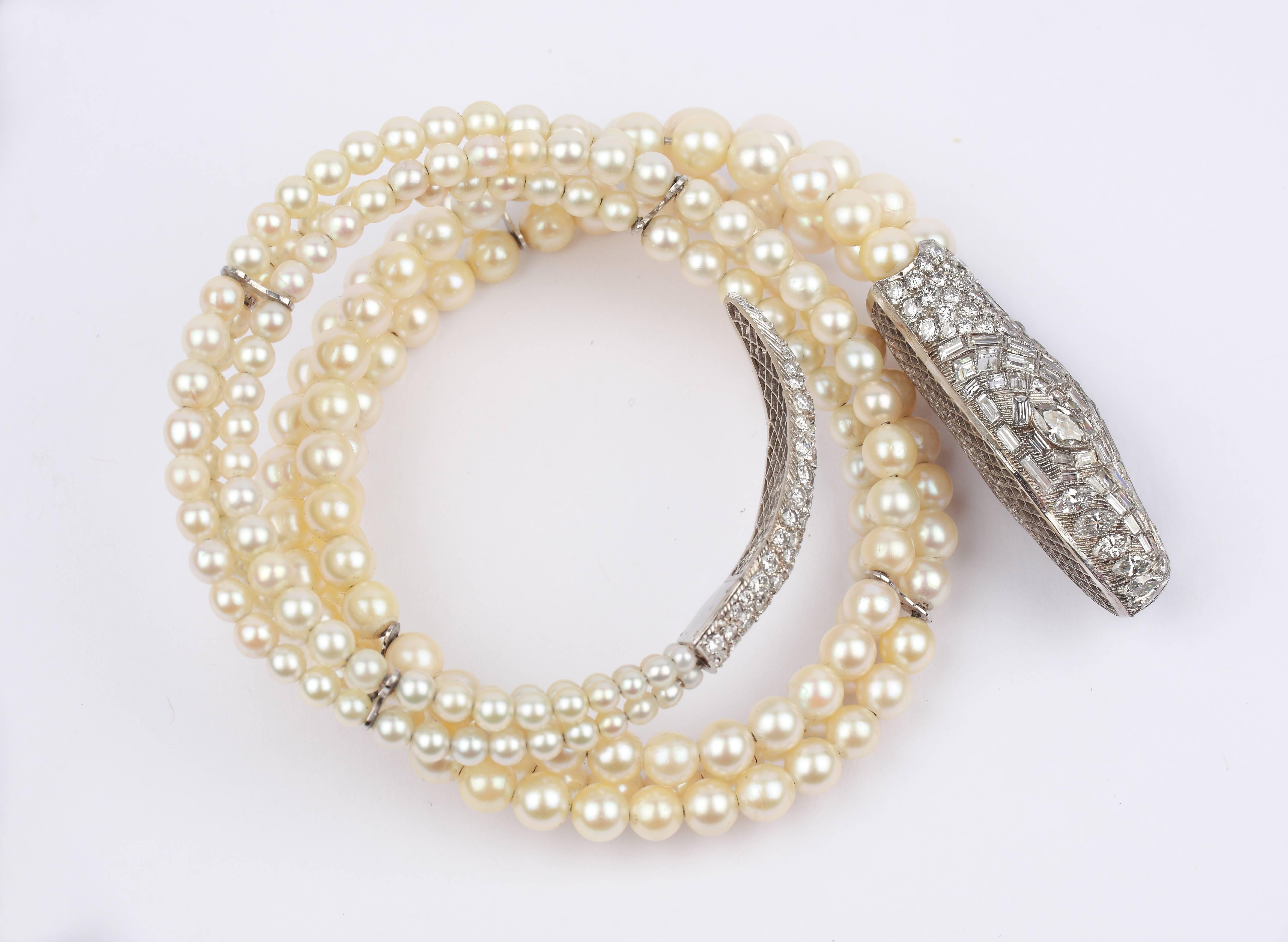 Designed in Argentina, 1930 as a pearl snake with aproximately 127 brilliant-cut diamonds, 87 baguette and carre-cut diamonds, 13 navette-cut diamonds with a total weight of ca. 16,37 ct. Three rows of pearls ( ca. 160 orient pearls, 56 culture
