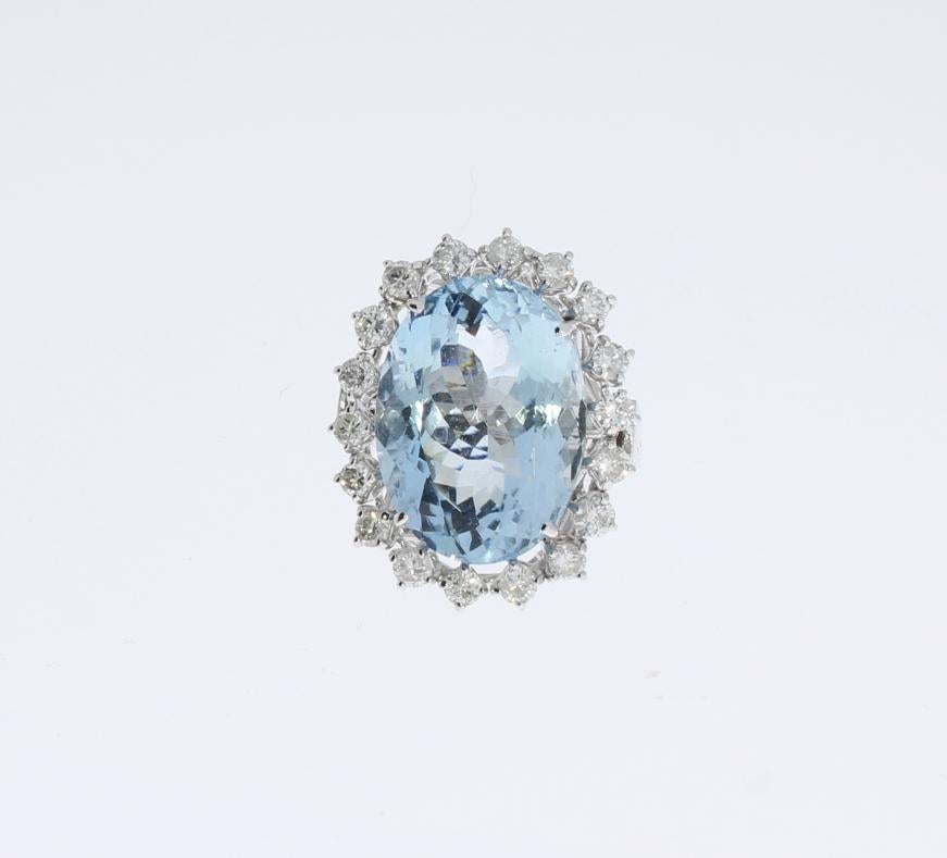 Europe, 1960's. Oval shaped aquamarine ( 19.31 x 13.96 x 9.41 mm ) weighing ca. 22,08 carat surrounded 
by 18 brilliant-cut diamonds with a total weight of ca. 0,90 carat. Mounted in 14 K white gold. 
Hallmarked inside with triangle, 5855 star of