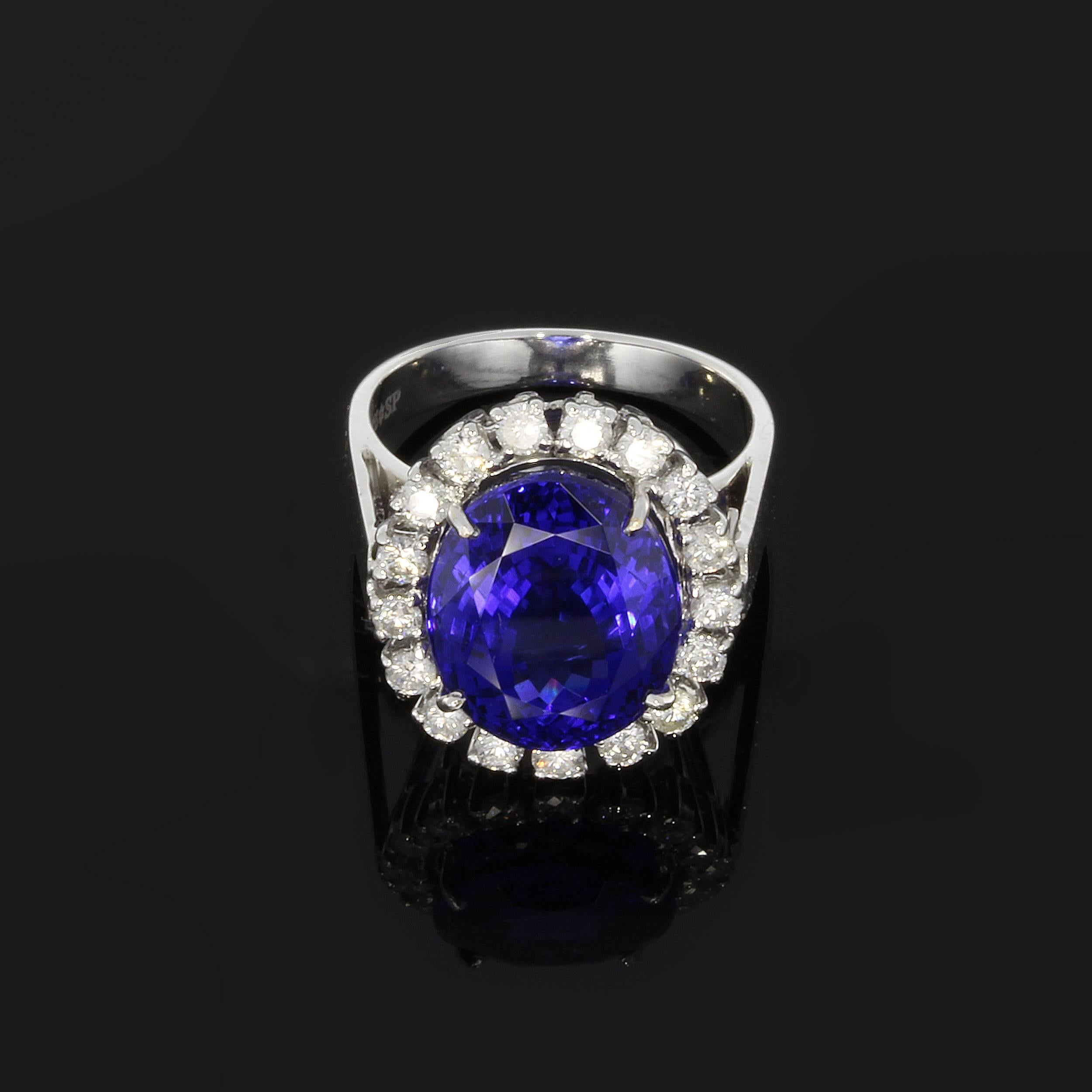 Germany, late 20th century. Set with oval shaped deep blue tanzanite weighing 11.56 ct. Surrounded by 17 diamonds totally 1.0 ct. color: Top Wesselton ( TW ), clarity: VVSI. Mounted in 14K white gold. Hallmarked inside with 585S star SP. Weight: